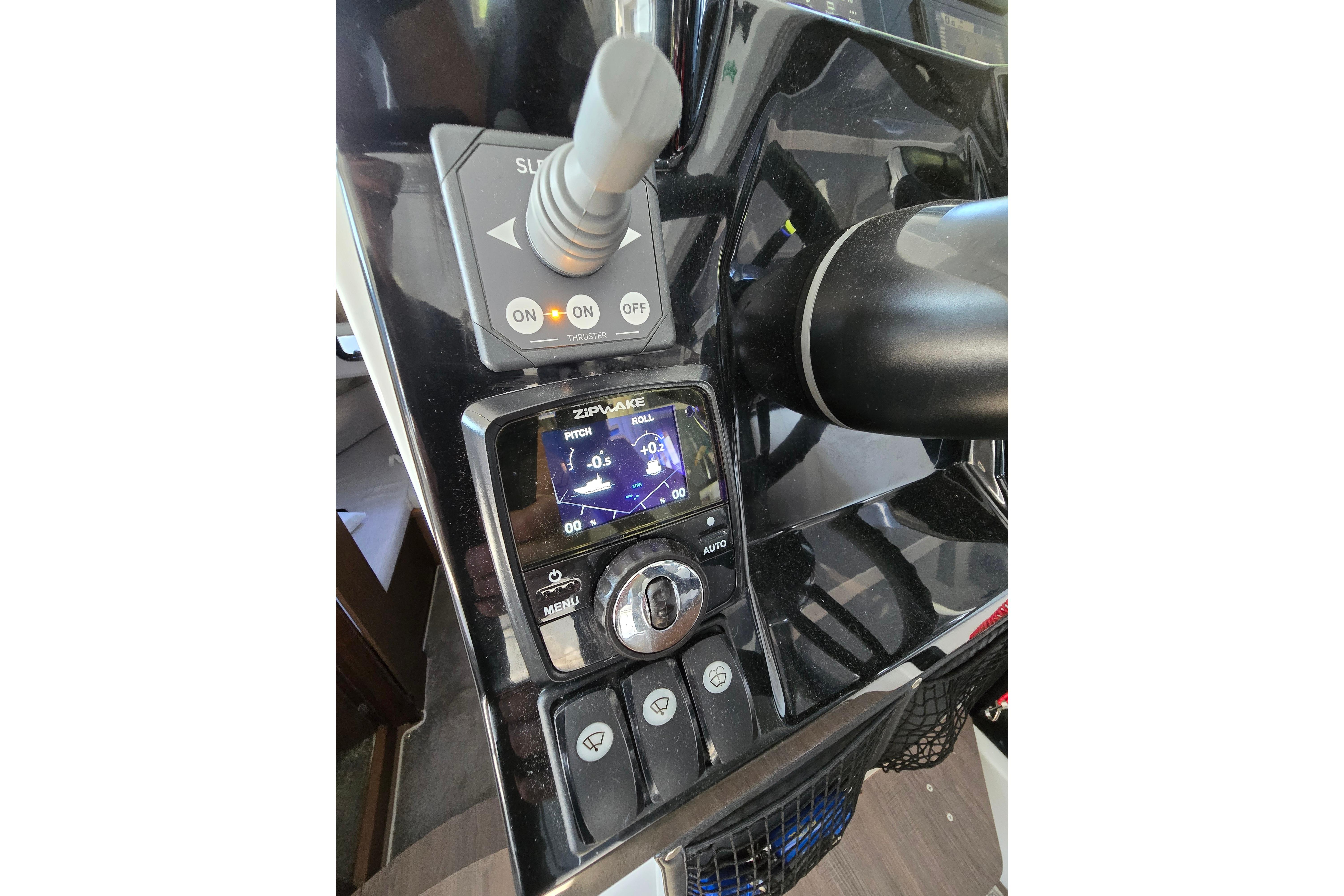Jeanneau NC Sport 895 helm with modern controls and display.