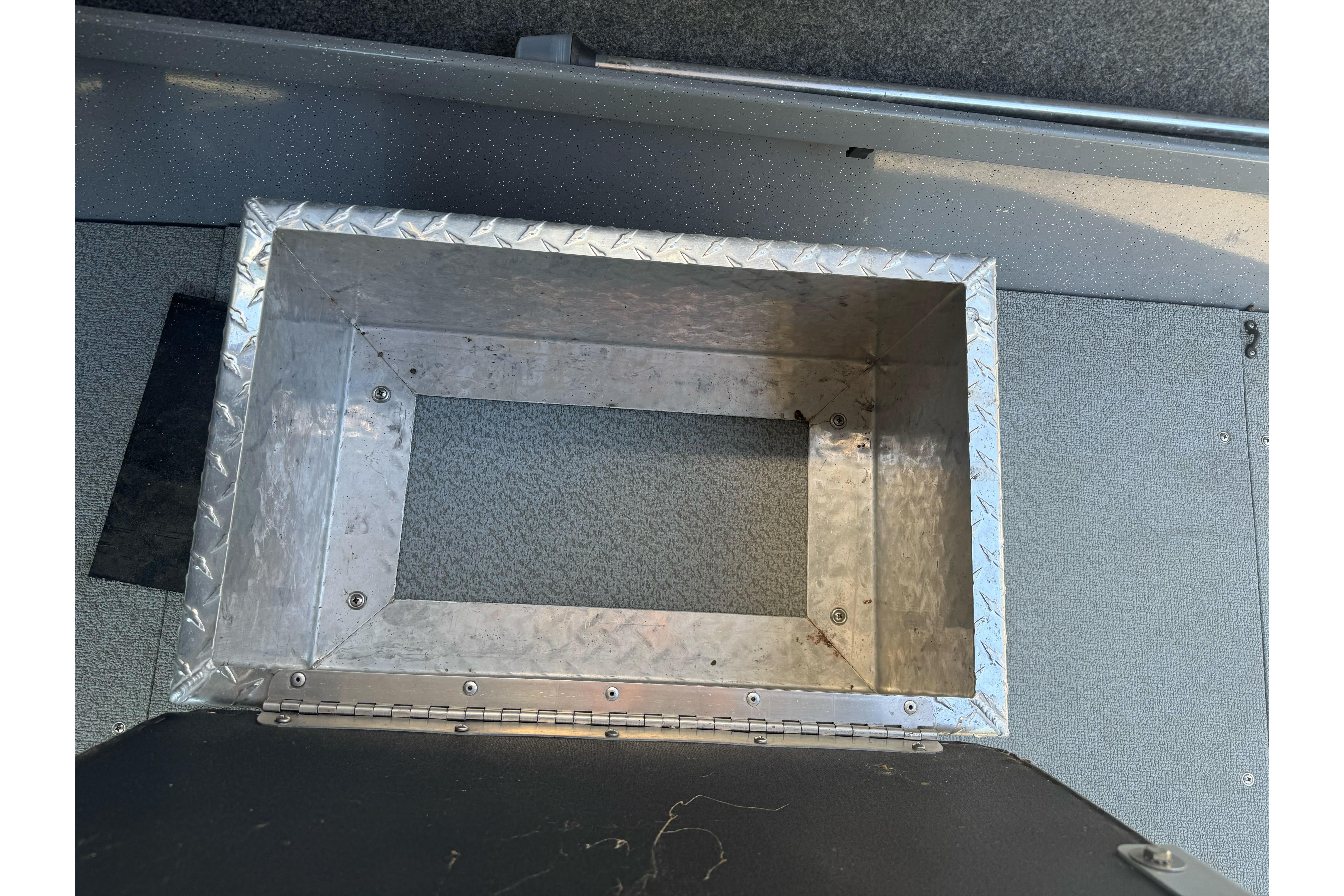 Aluminum storage compartment in 2014 River Hawk 19 GB boat interior.