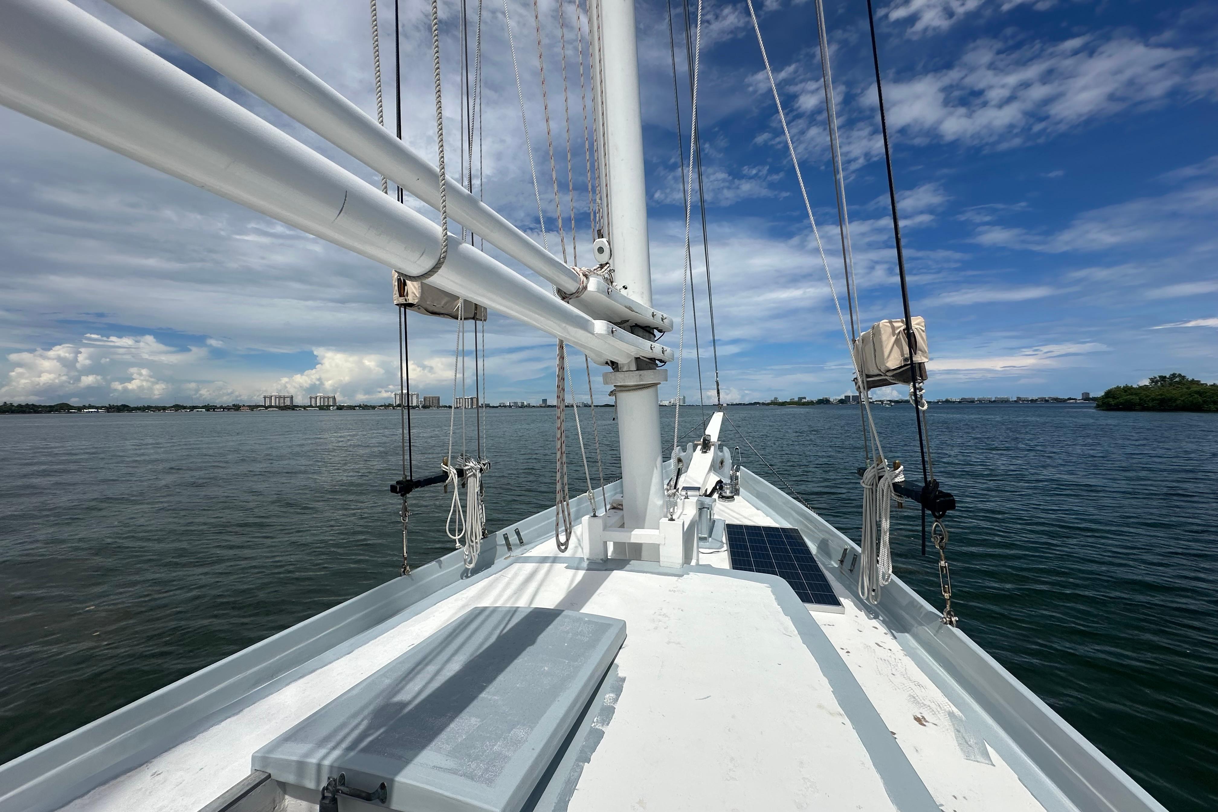 Schooner Leopard 1994 sailing on calm waters under a partly cloudy sky.