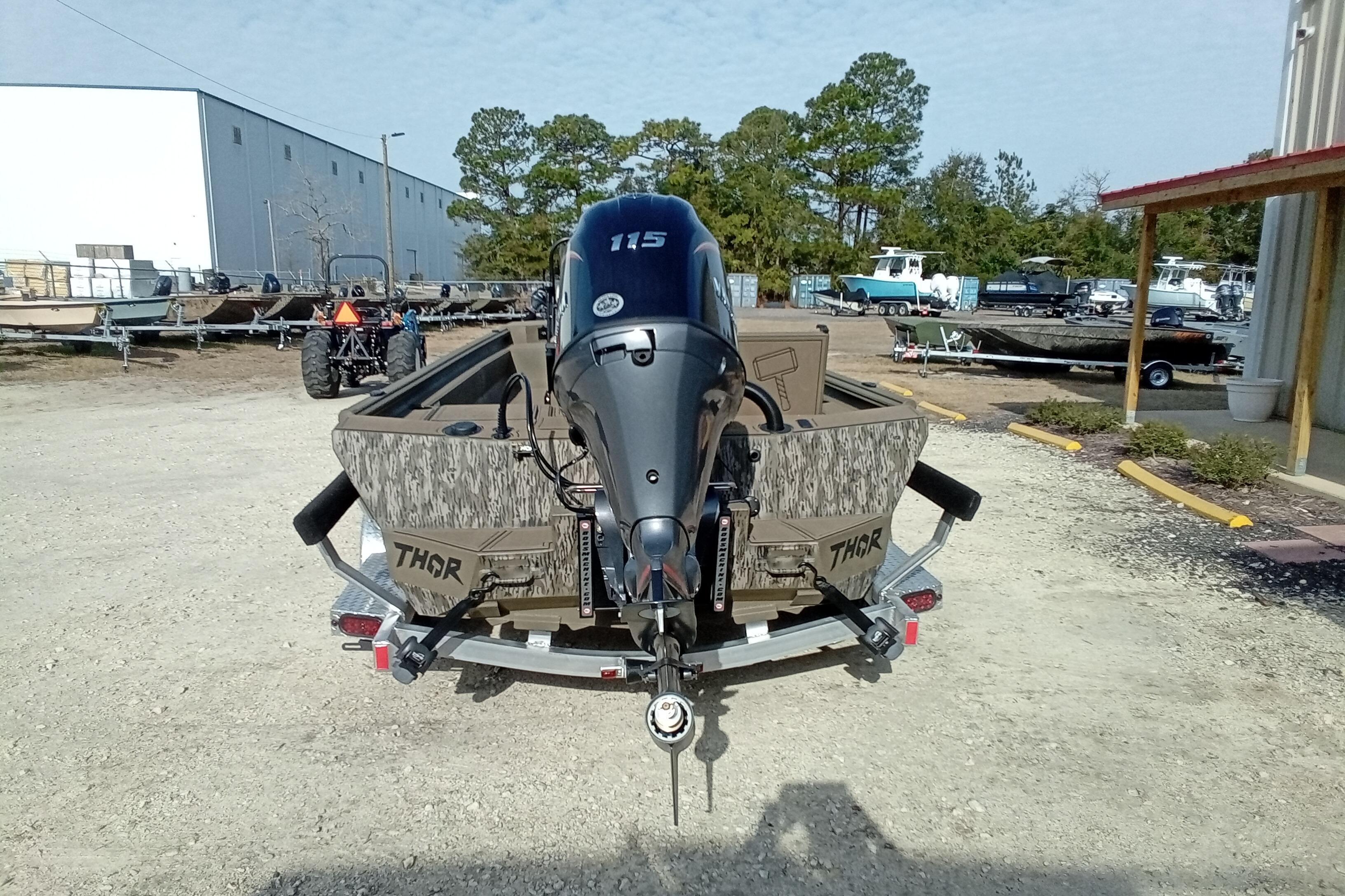 2026 Thor 1900 Low Country Elite boat with 115 HP engine, parked outdoors.