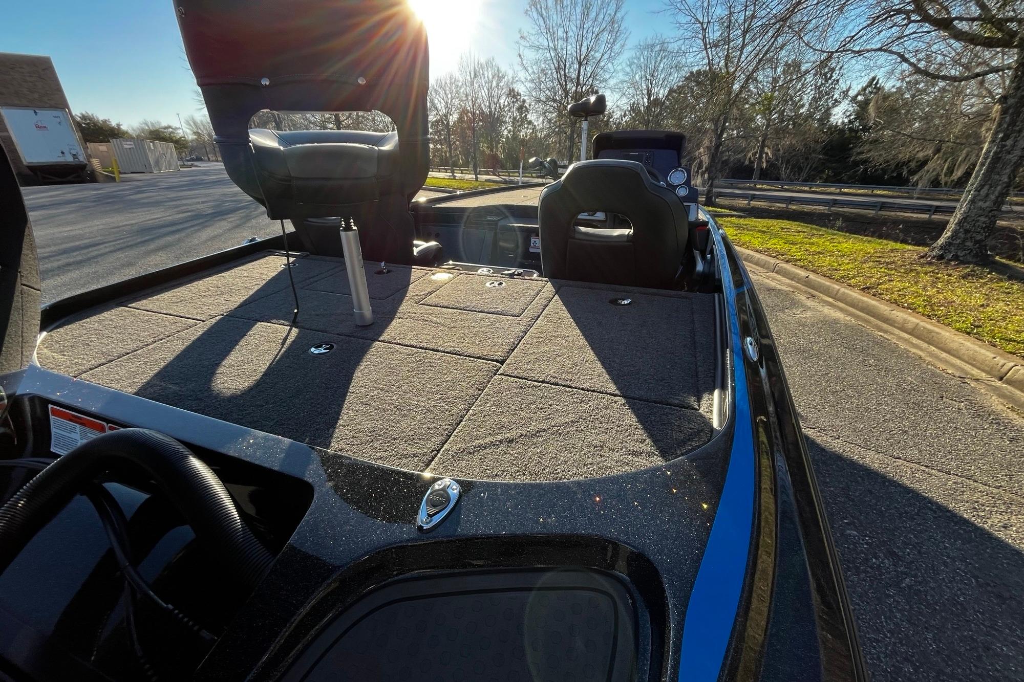 2024 Nitro Z19 boat interior with seating and storage, parked outdoors in sunlight.