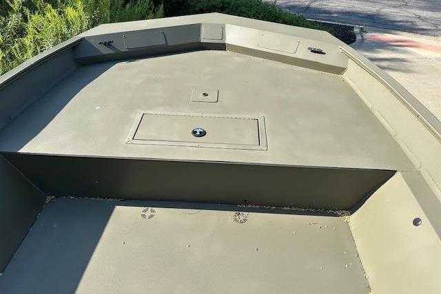 2025 Tracker GRIZZLY 2072 Utility boat deck, featuring storage compartments and durable design.