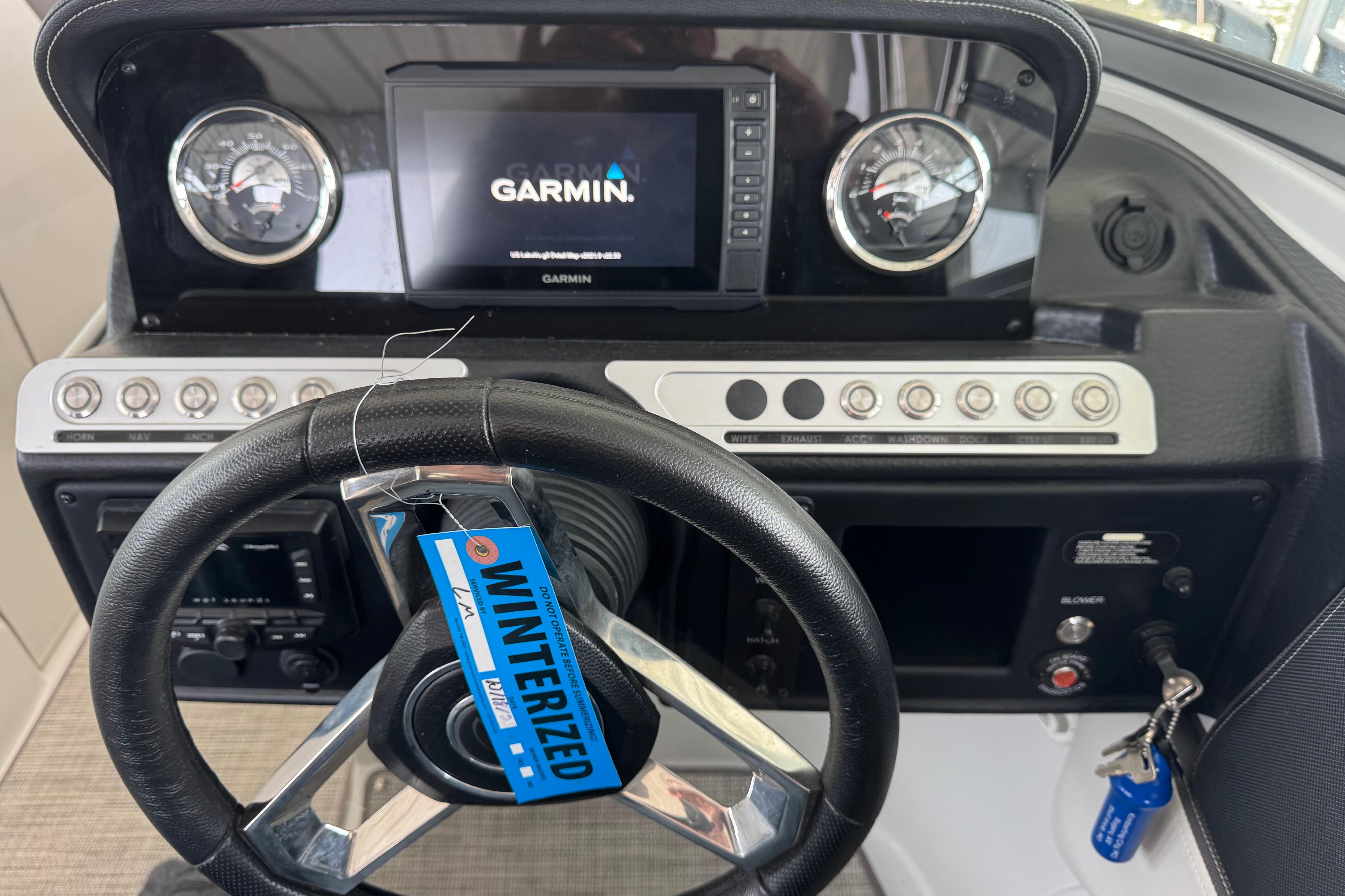 2022 Crownline 265 SS dashboard with Garmin display and winterized tag.