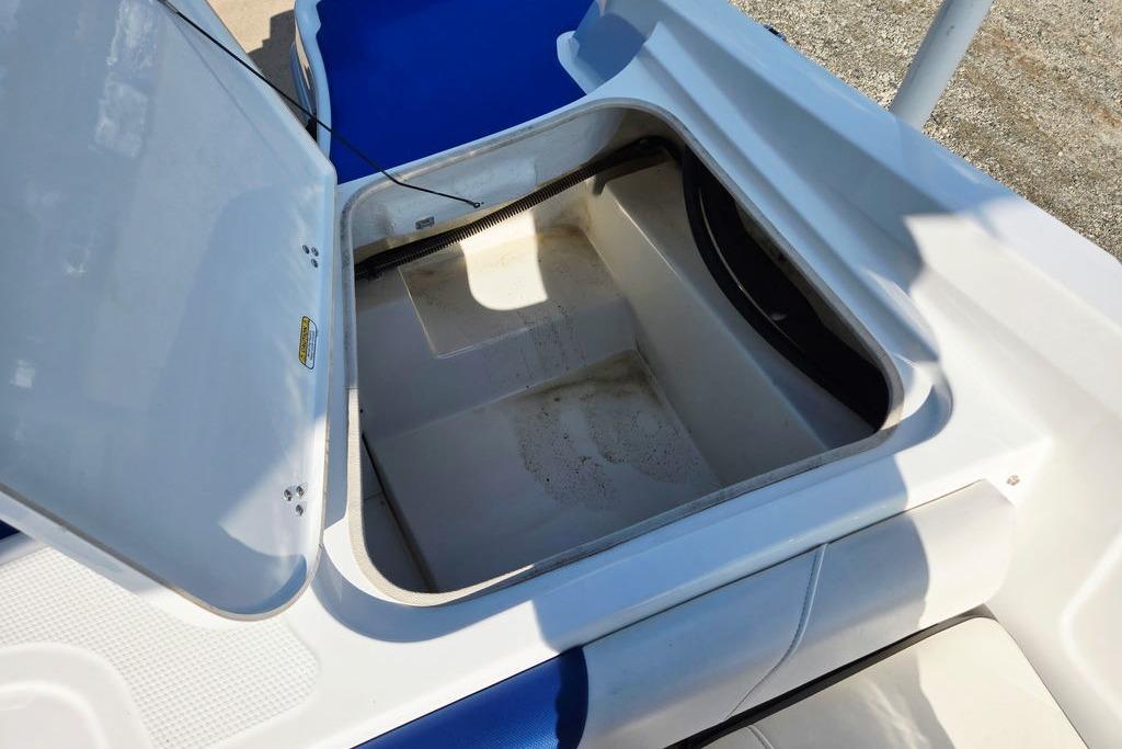 Open storage compartment on a 2018 Tahoe 450 TS boat, showing interior space.