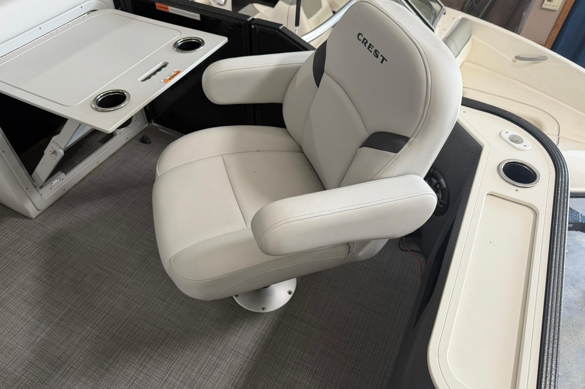 2023 Crest Classic LX 200 boat interior with plush captain's chair and foldable table.