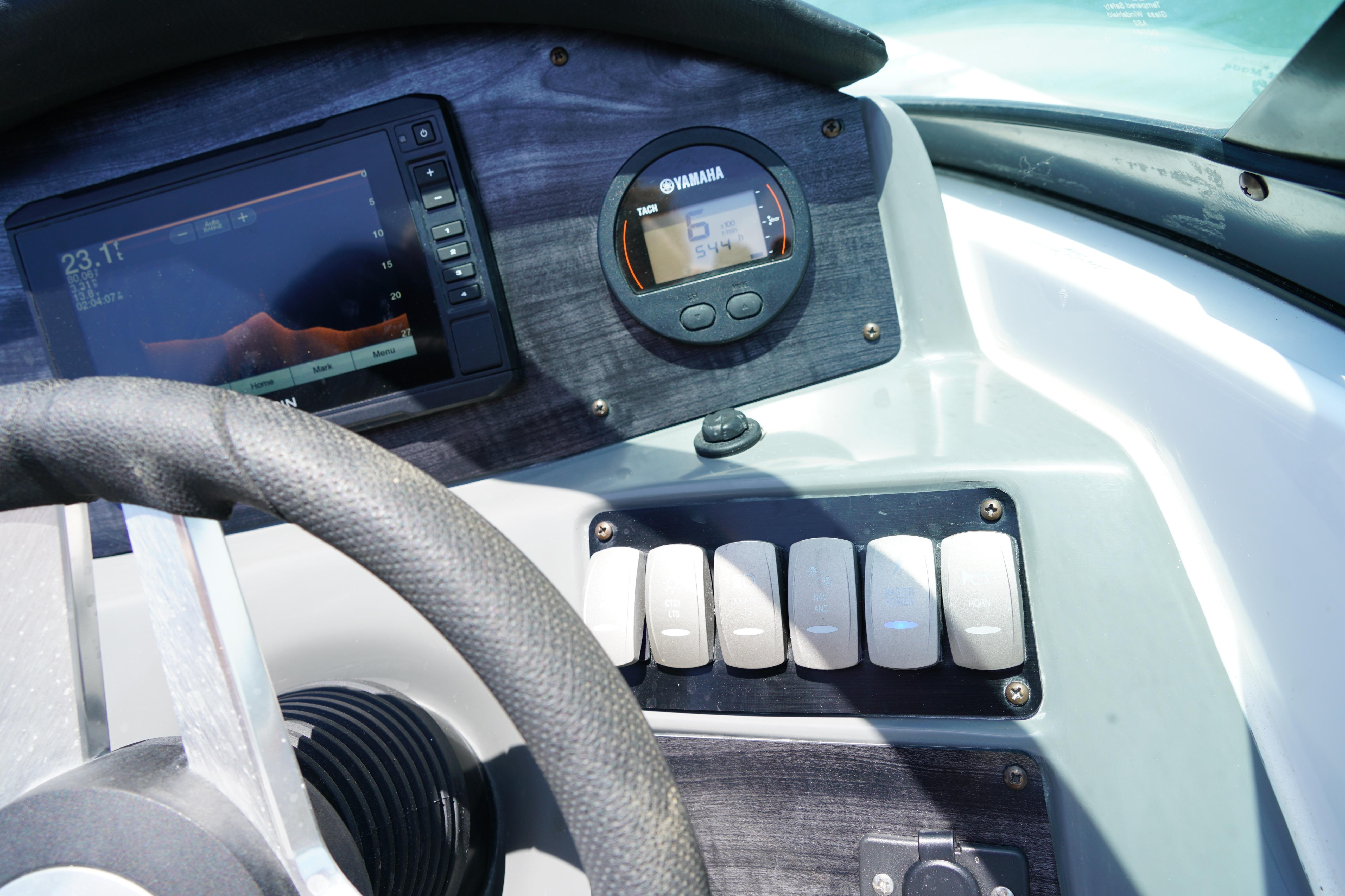 Dashboard of 2020 Hurricane SunDeck 2486 OB boat with Yamaha gauge and control switches.