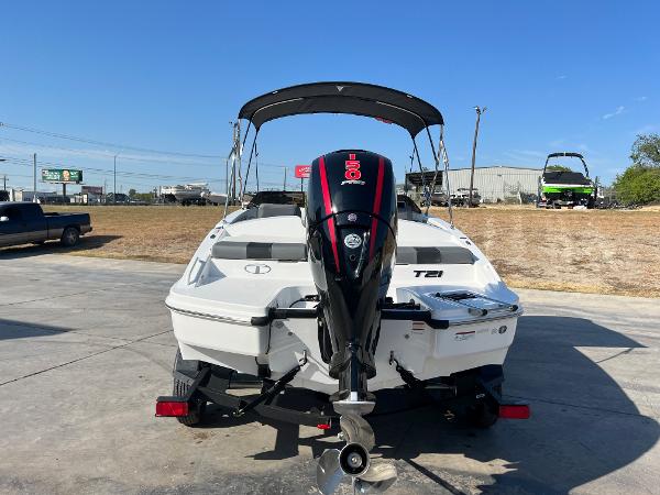 2024 Tahoe T21 boat with outboard motor, rear view, parked on concrete lot.
