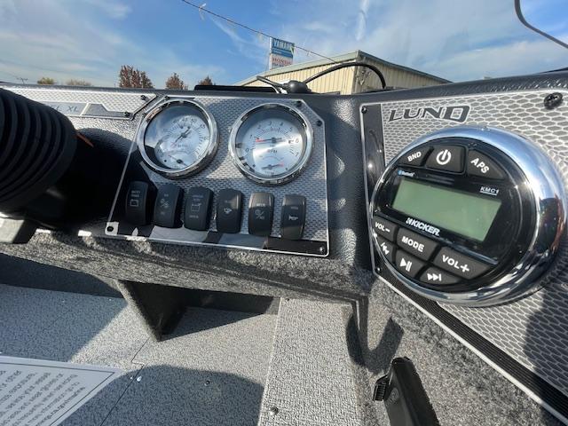 2025 Lund 1650 Rebel XL SS dashboard with gauges and audio controls.