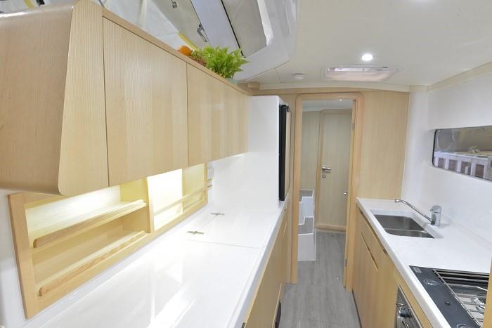 Modern kitchen interior of 2025 Seawind 1170 yacht with sleek cabinetry and appliances.