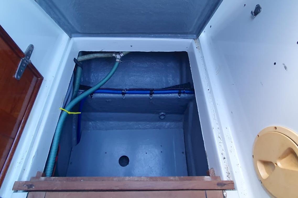 Interior compartment of 1989 Fairey Spearfish MKIII boat, featuring pipes and storage space.