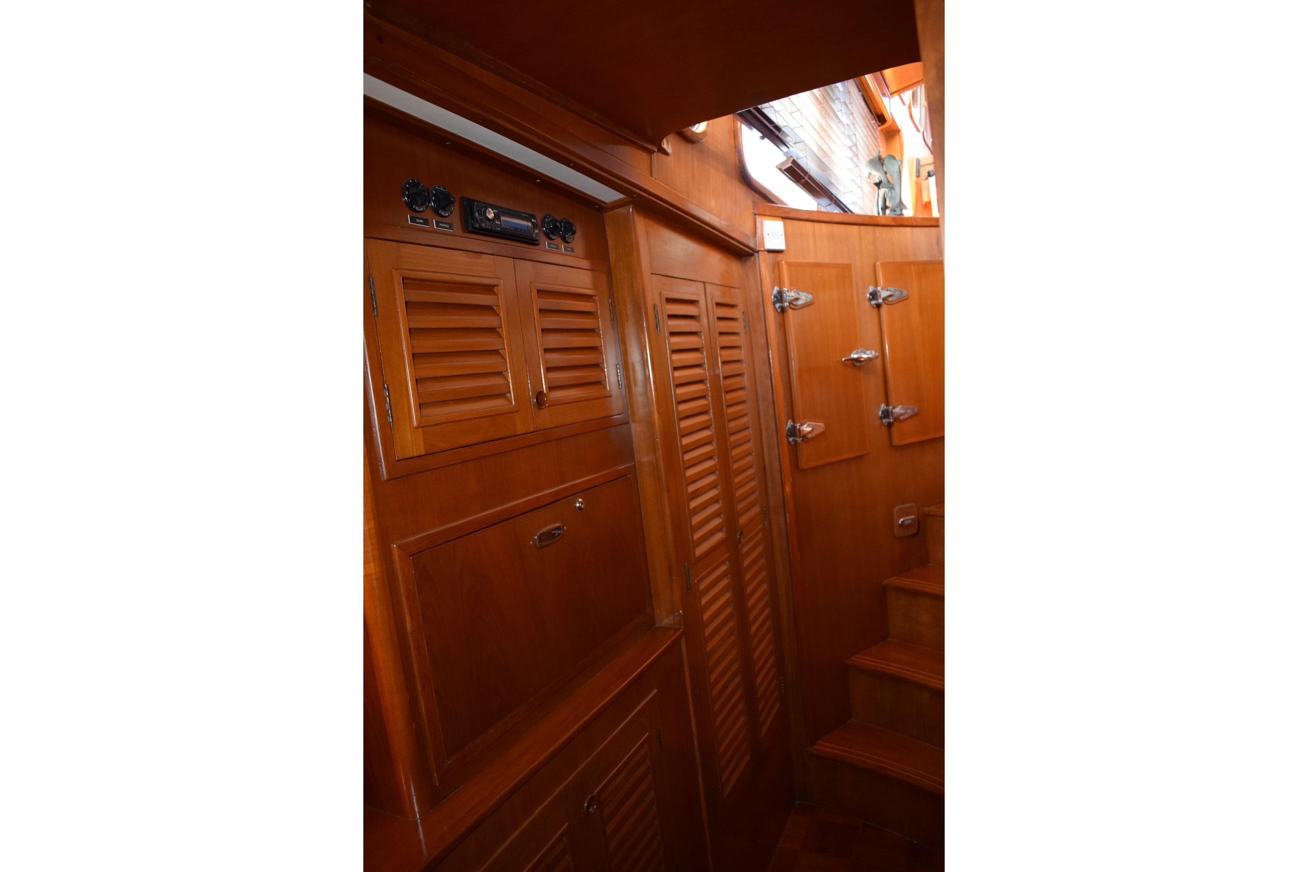 Interior of 1980 Cheoy Lee 52 Motorsailer with wooden cabinetry and steps.