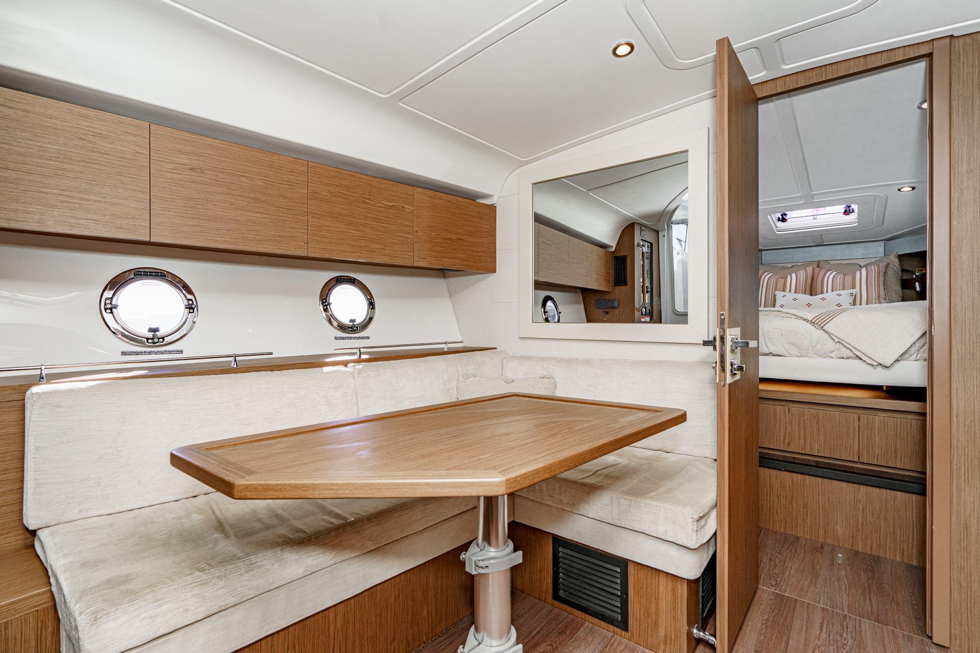 Interior of 2018 Beneteau Gran Turismo 40 yacht with cozy dining area and cabin.