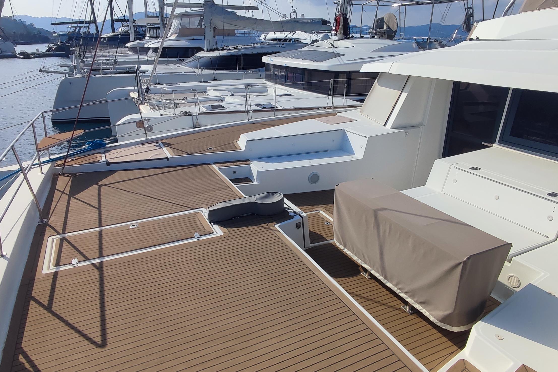 2021 Bali 5.4 yacht deck with modern design, docked in a marina.