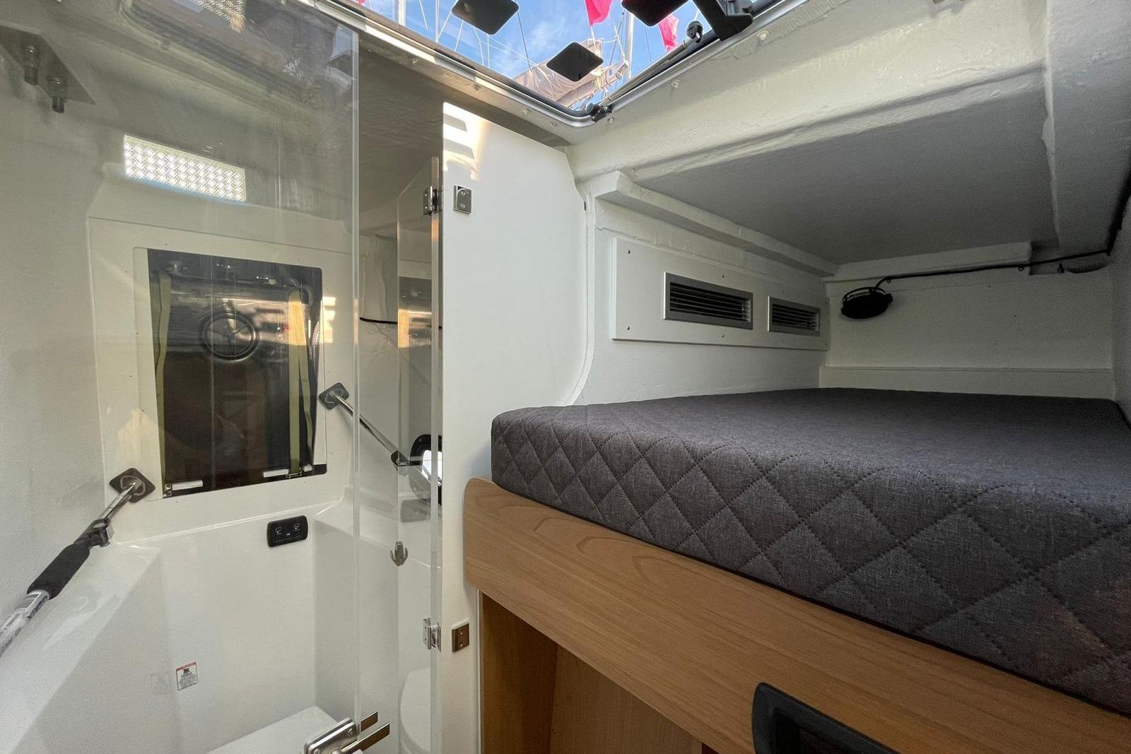Interior of 2026 Bali 5.8 yacht cabin with bed and shower area.