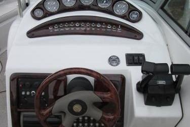 2004 Crownline 288 BR boat dashboard with steering wheel and control panel.