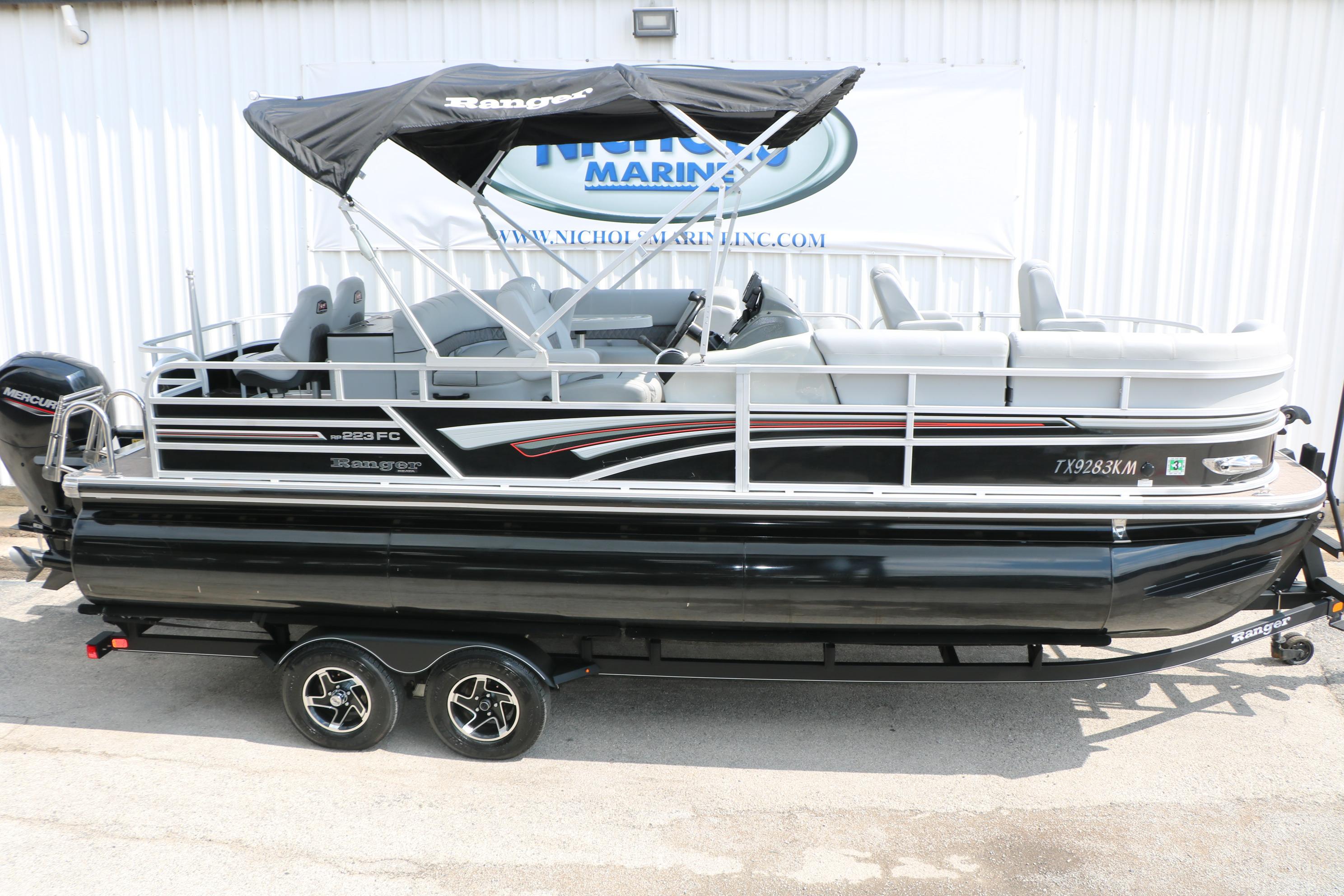 2021 Ranger 223FC pontoon boat with canopy on trailer, side view.