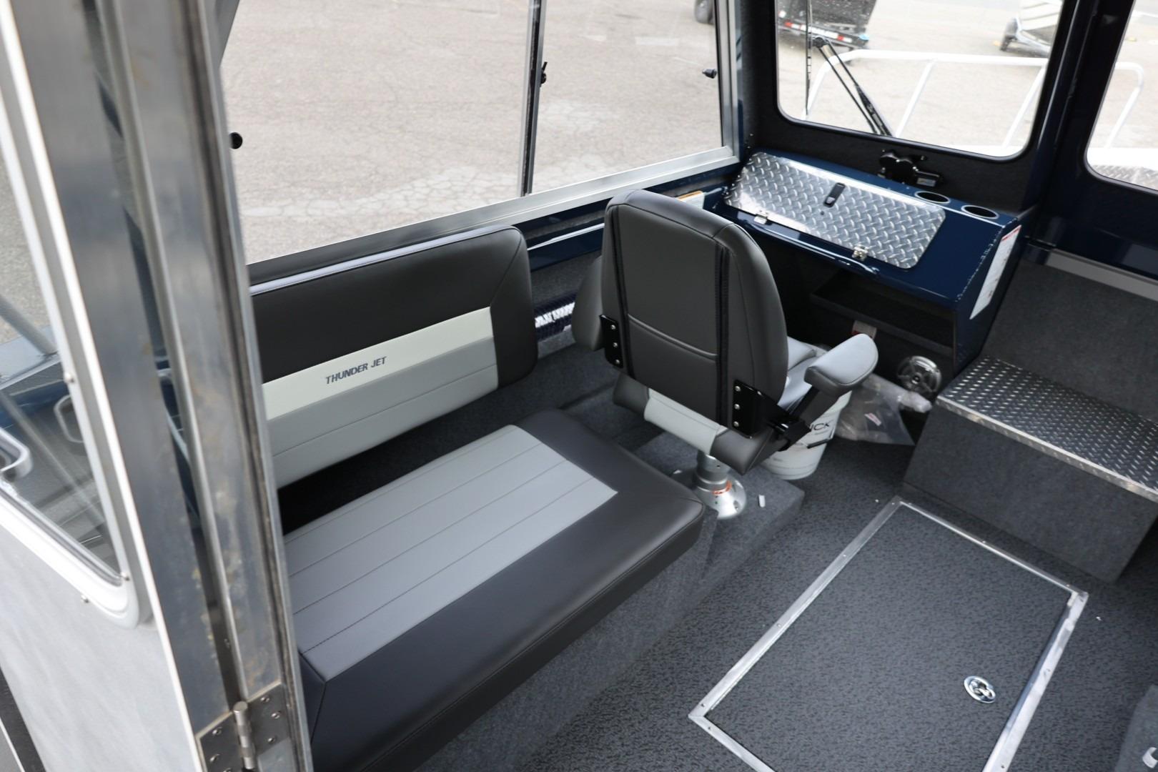 Interior of 2026 Thunder Jet 24 Alexis Pro boat with seating and control panel.