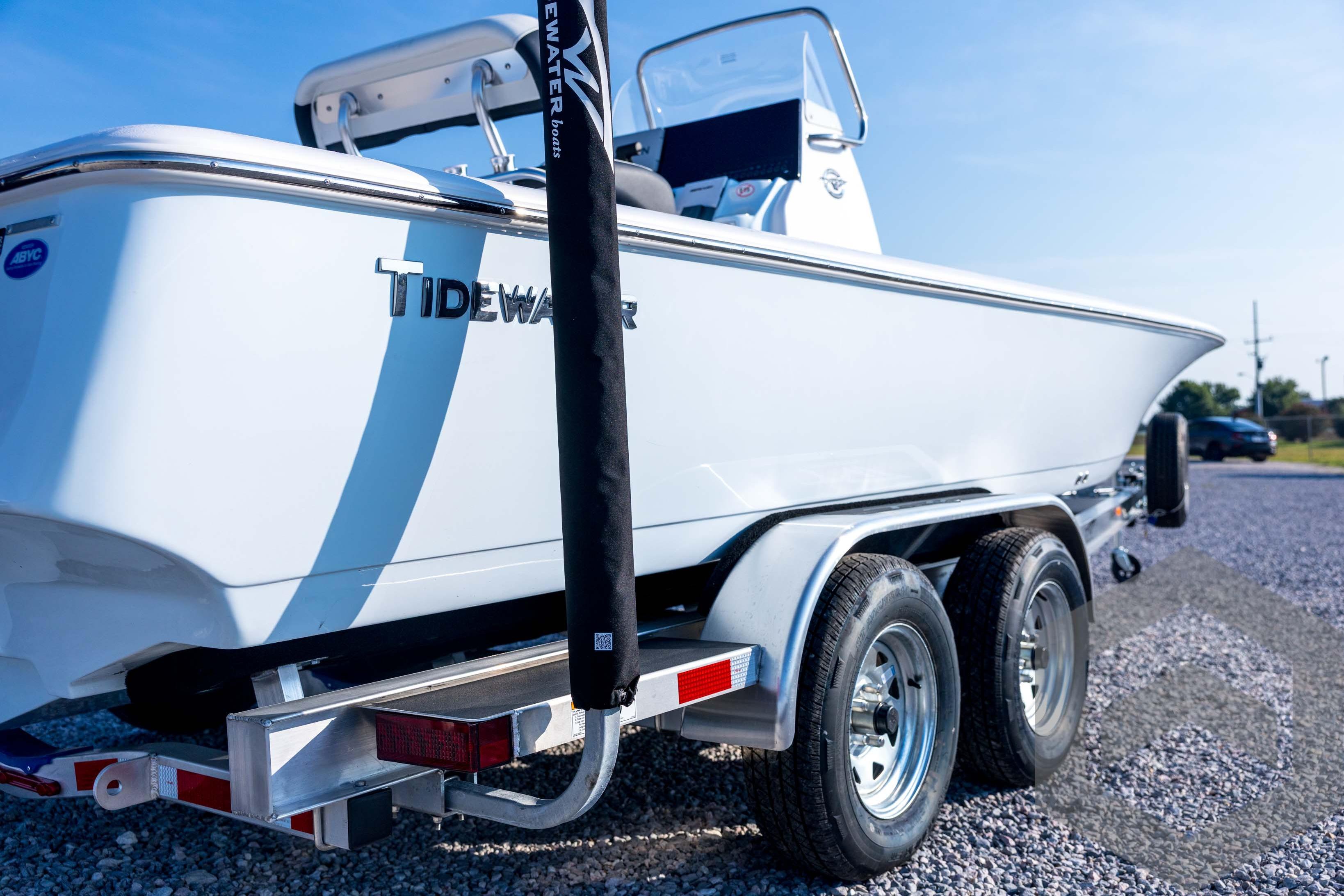 2026 Tidewater 2110 Bay Max boat on trailer, parked on gravel under clear sky.