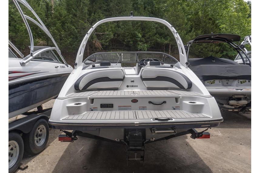 2021 Yamaha Boats 195S, rear view, parked among other boats, showcasing sleek design.