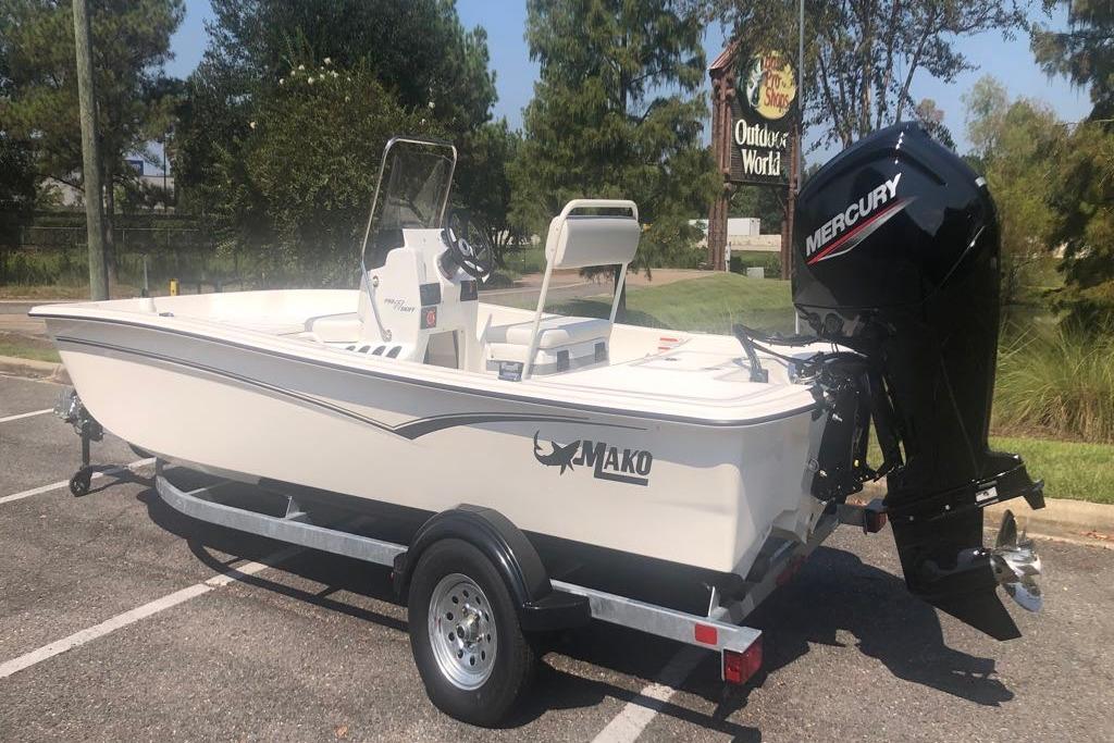 2026 Mako Pro Skiff 17 CC boat with Mercury engine on trailer in parking lot.