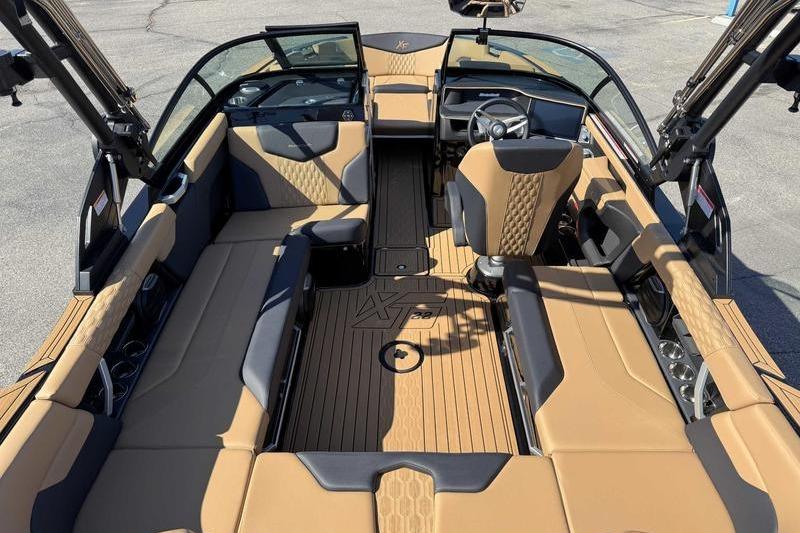 2026 MasterCraft XT22 boat interior with tan and black seating, sleek design.
