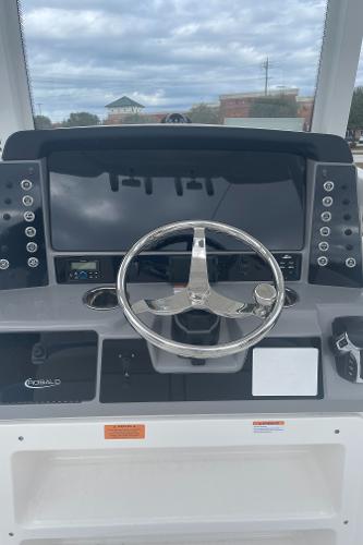 2026 Robalo 246 Cayman boat dashboard with steering wheel and control panel.