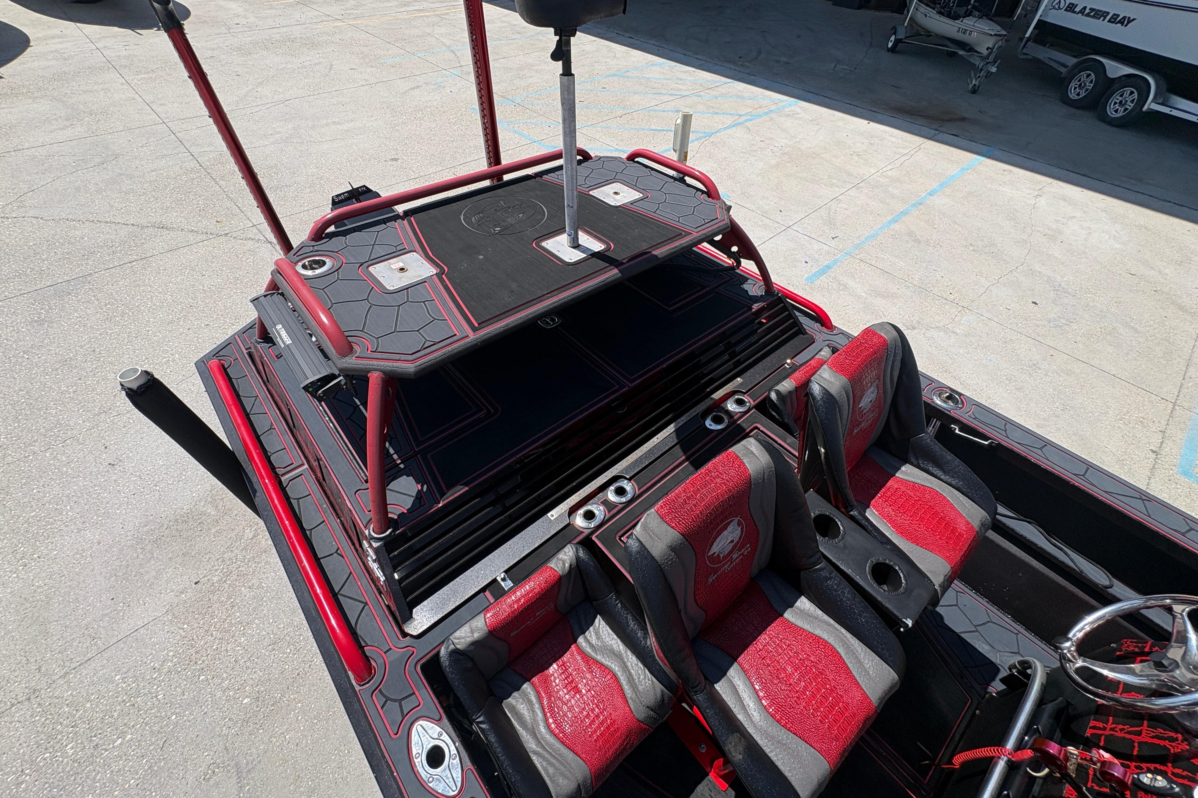 2018 Custom Swamp Shark 24' boat with red and black seating and deck design.