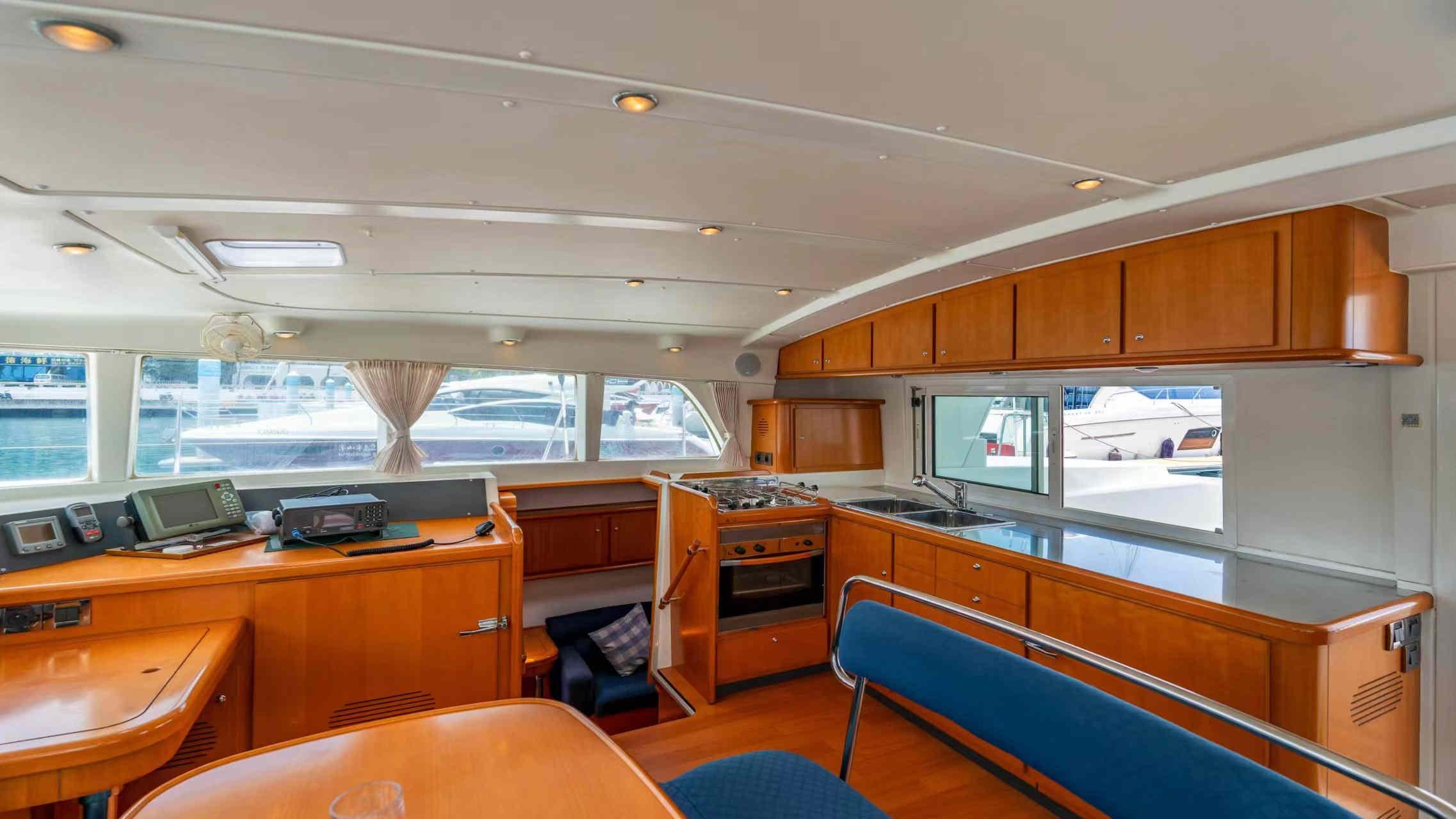 Interior of 2007 Lagoon 440 yacht with modern kitchen and panoramic windows.
