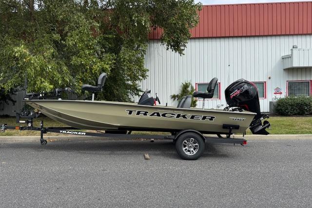 2026 Tracker Pro Team 190 boat on trailer, parked outdoors near a building.