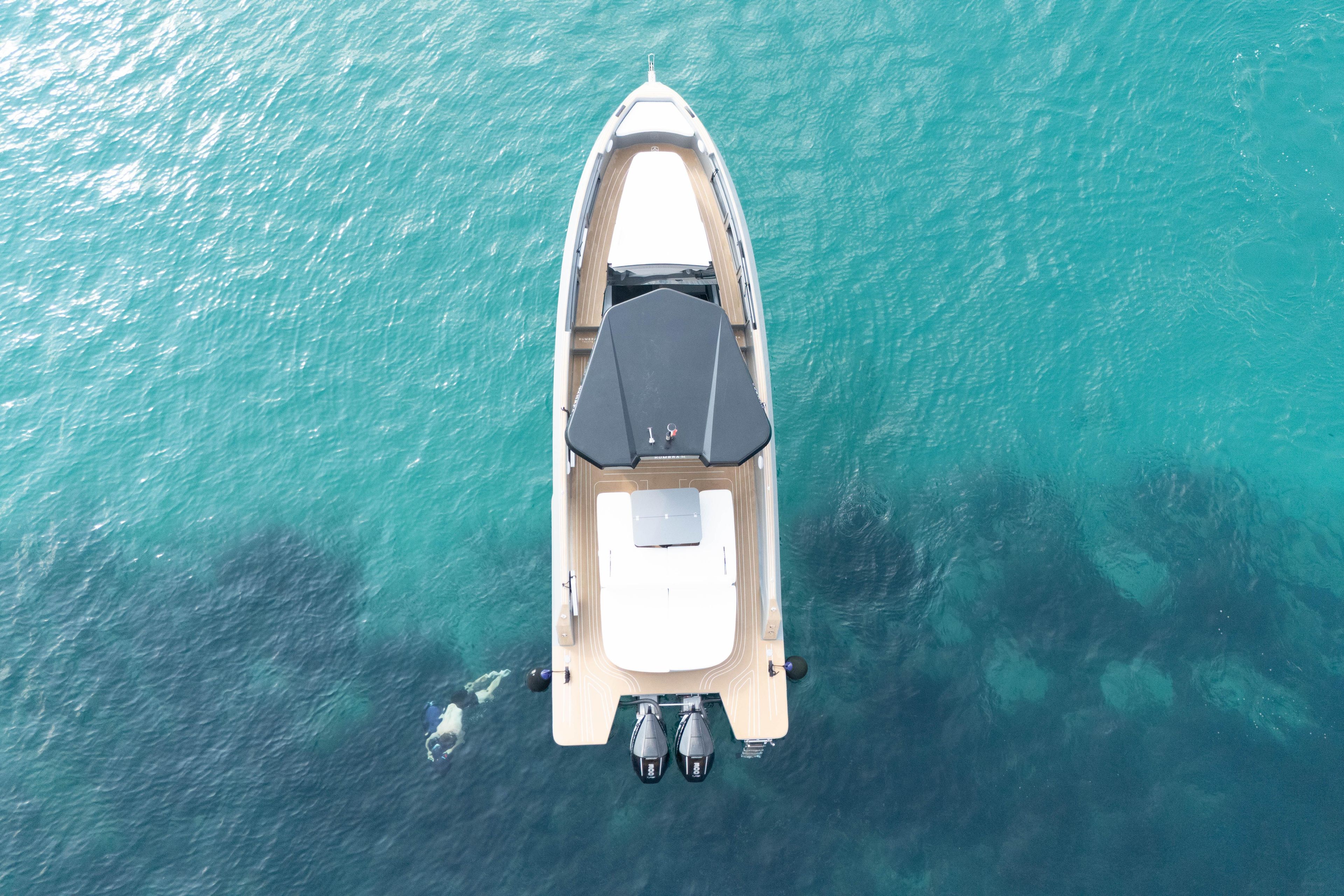 Aerial view of 2025 Kumbra 34 boat on clear turquoise water.