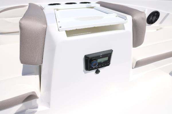 2025 Hurricane SunDeck Sport 205 OB boat interior with stereo system and cushioned seating.