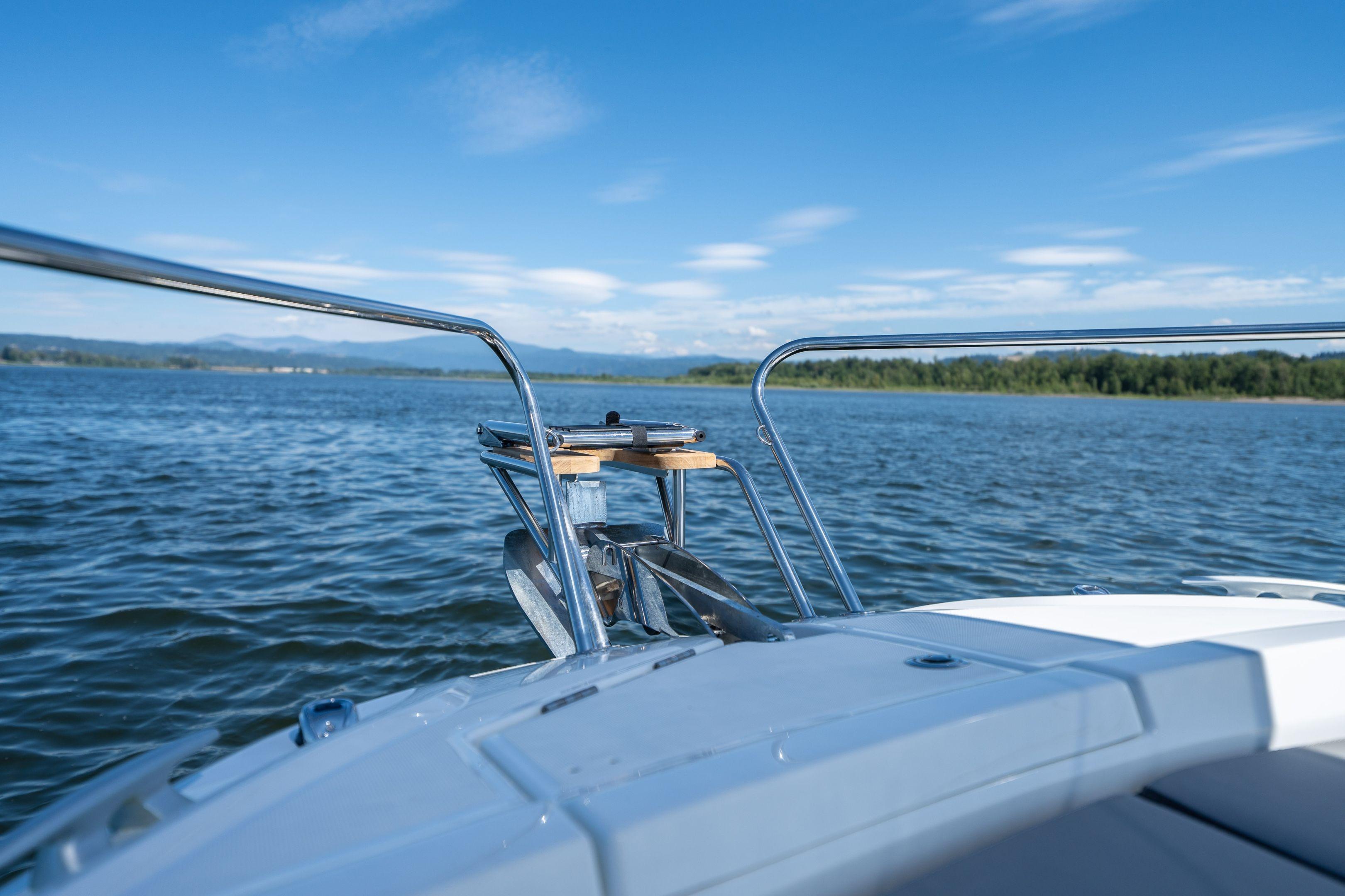 2026 Jeanneau Leader 7.5 WA Series 3 cruising on a serene lake under a clear blue sky.