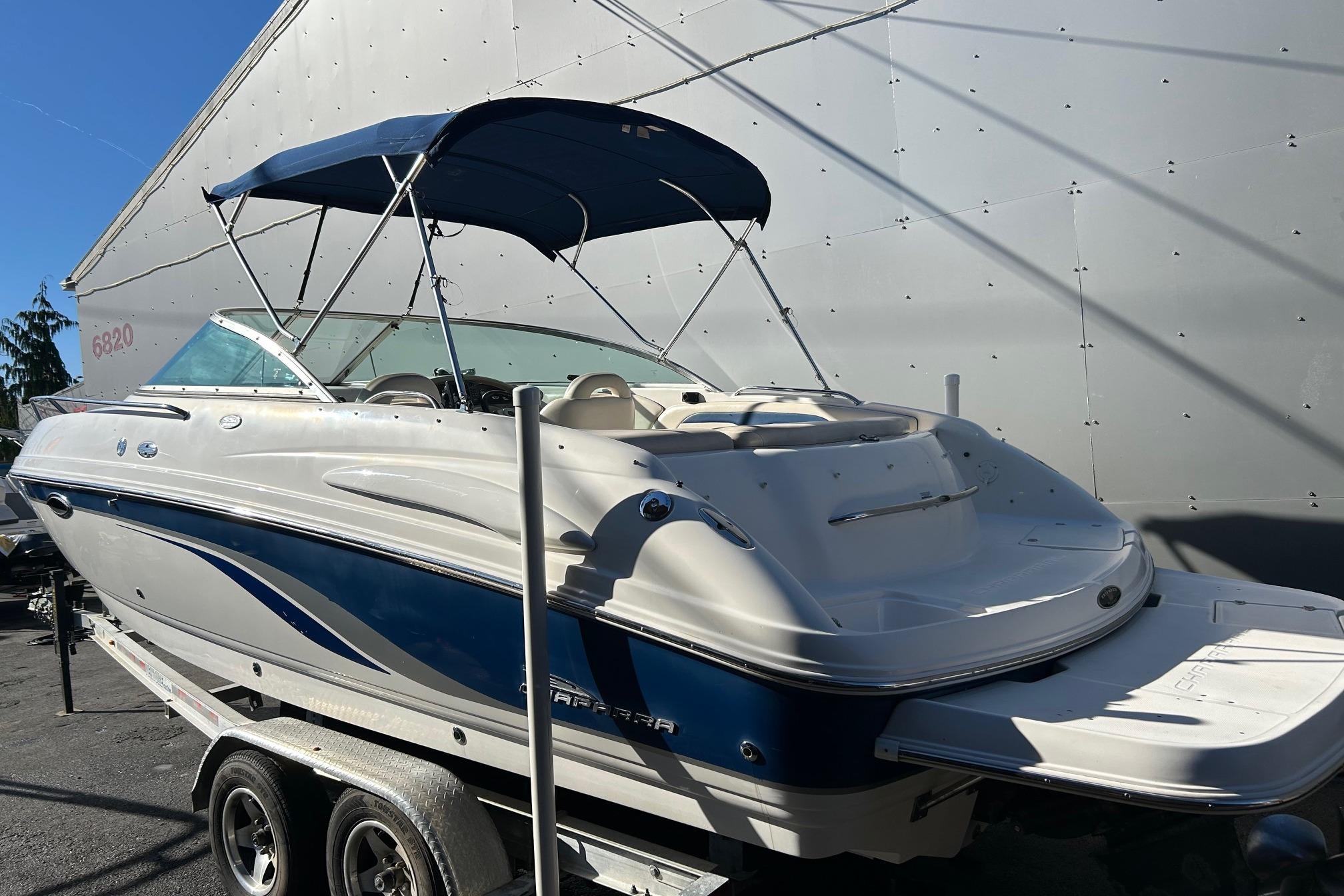 2001 Chaparral 235 SSi boat with blue and white exterior, parked on a trailer.