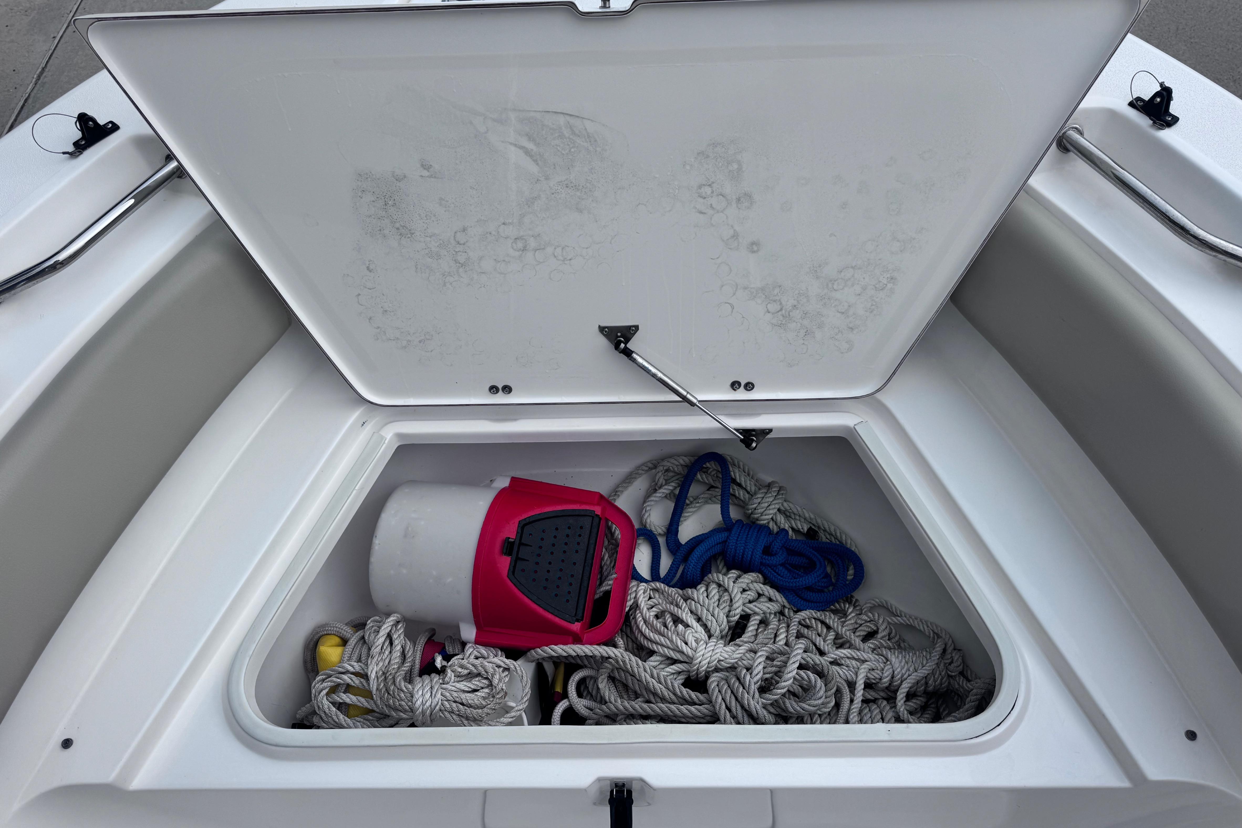 Open storage compartment on 2018 Sea Fox 206 Commander boat with ropes and equipment.