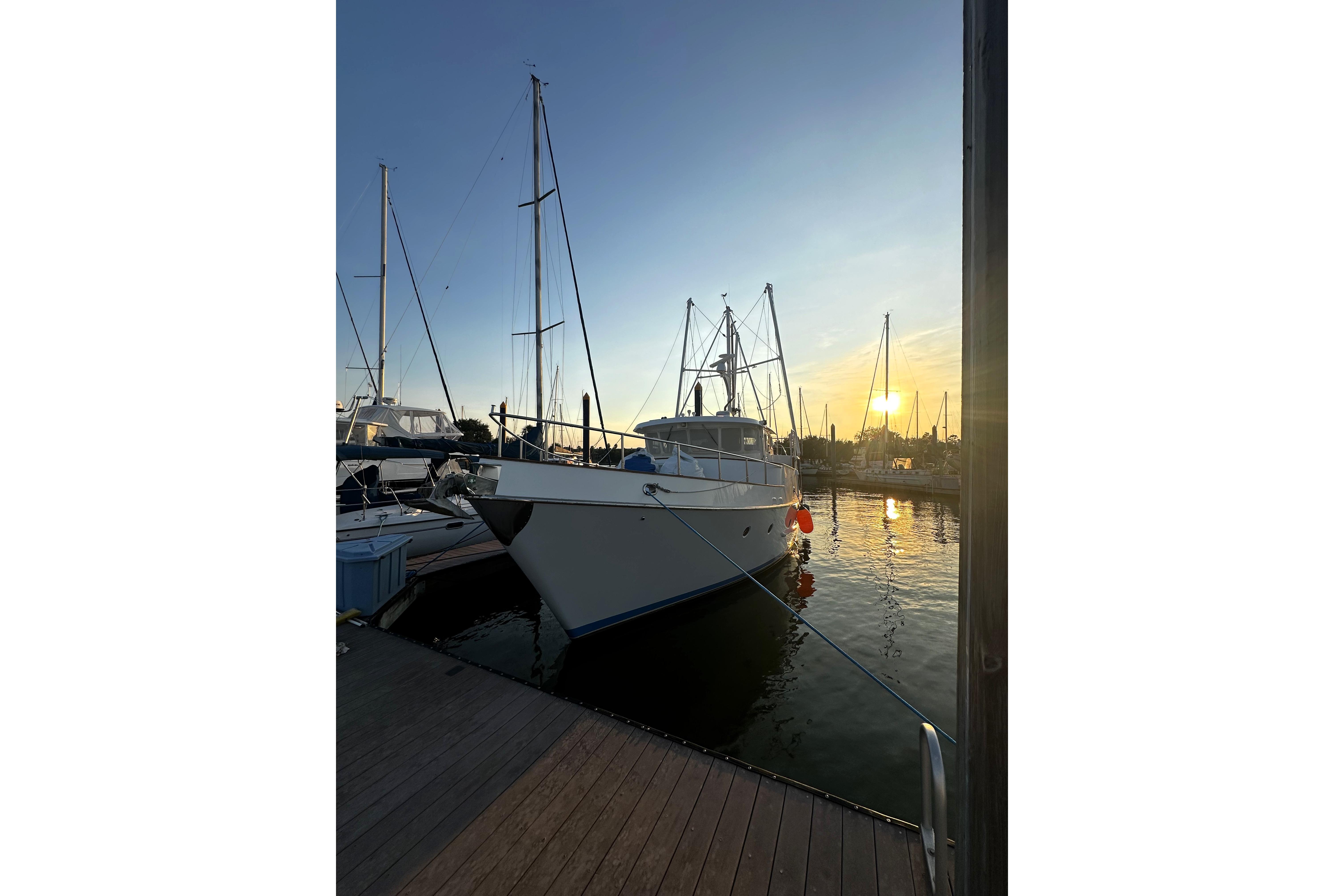 Nordhavn 46 yacht docked at sunset, 1998 model, serene marina setting.