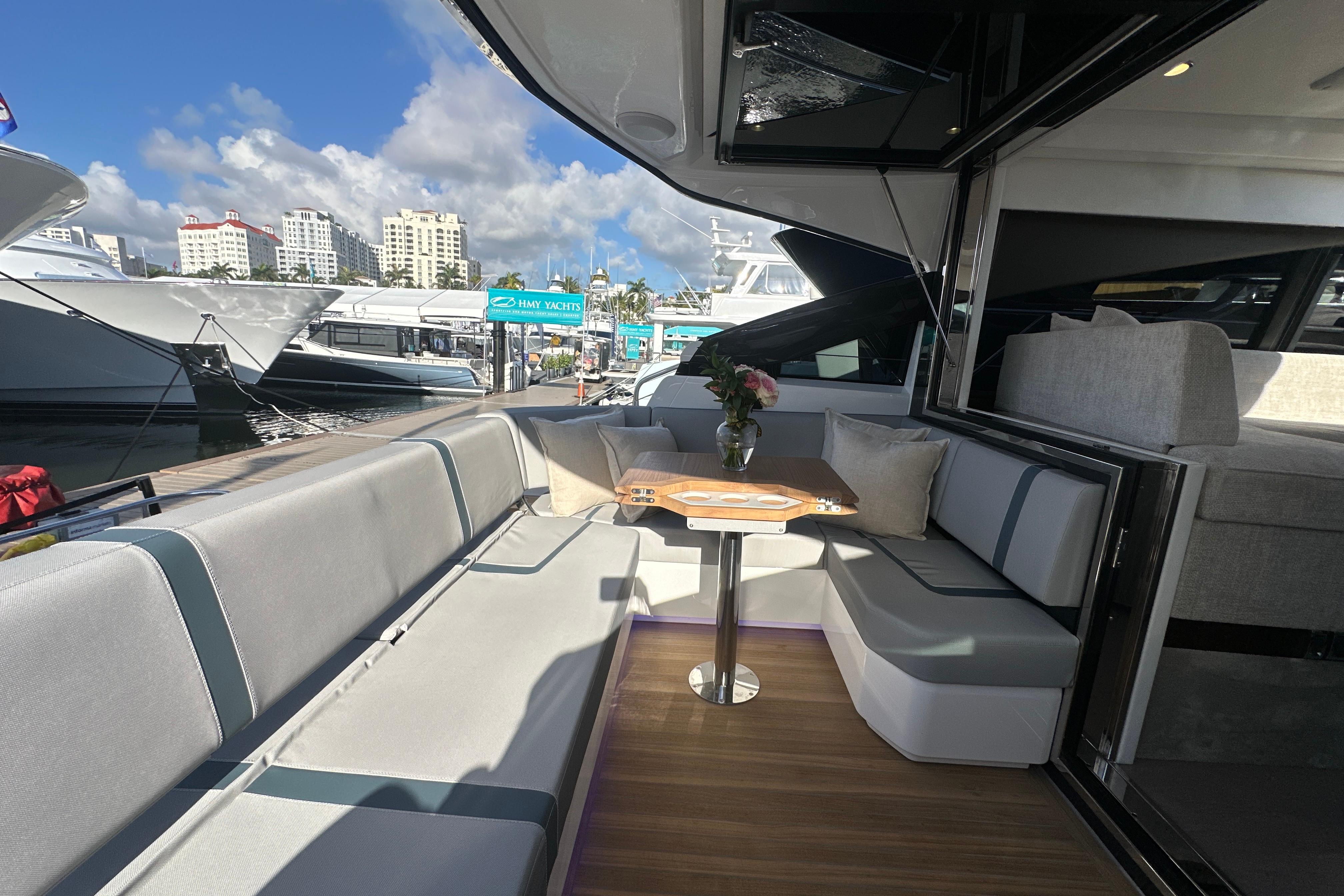 Luxurious 2026 Fairline Targa 47 GT yacht interior with elegant seating and table.