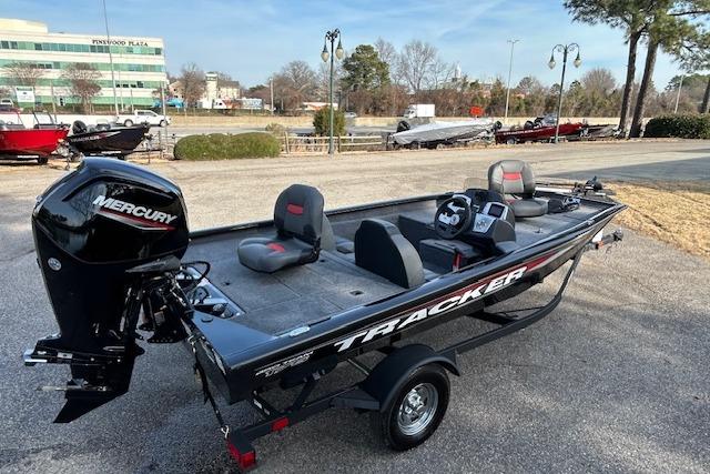 2026 Tracker Pro Team 175 boat with Mercury engine, parked outdoors.