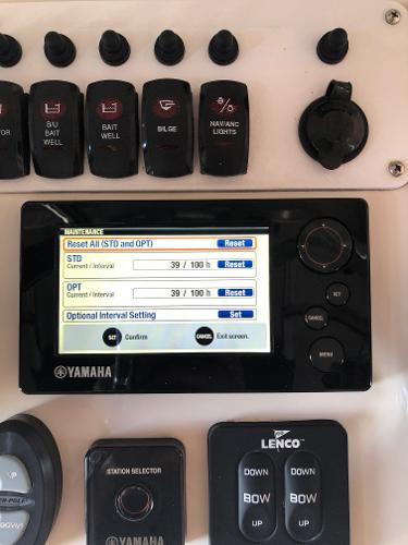 Close-up of a control panel with Yamaha screen and various switches.