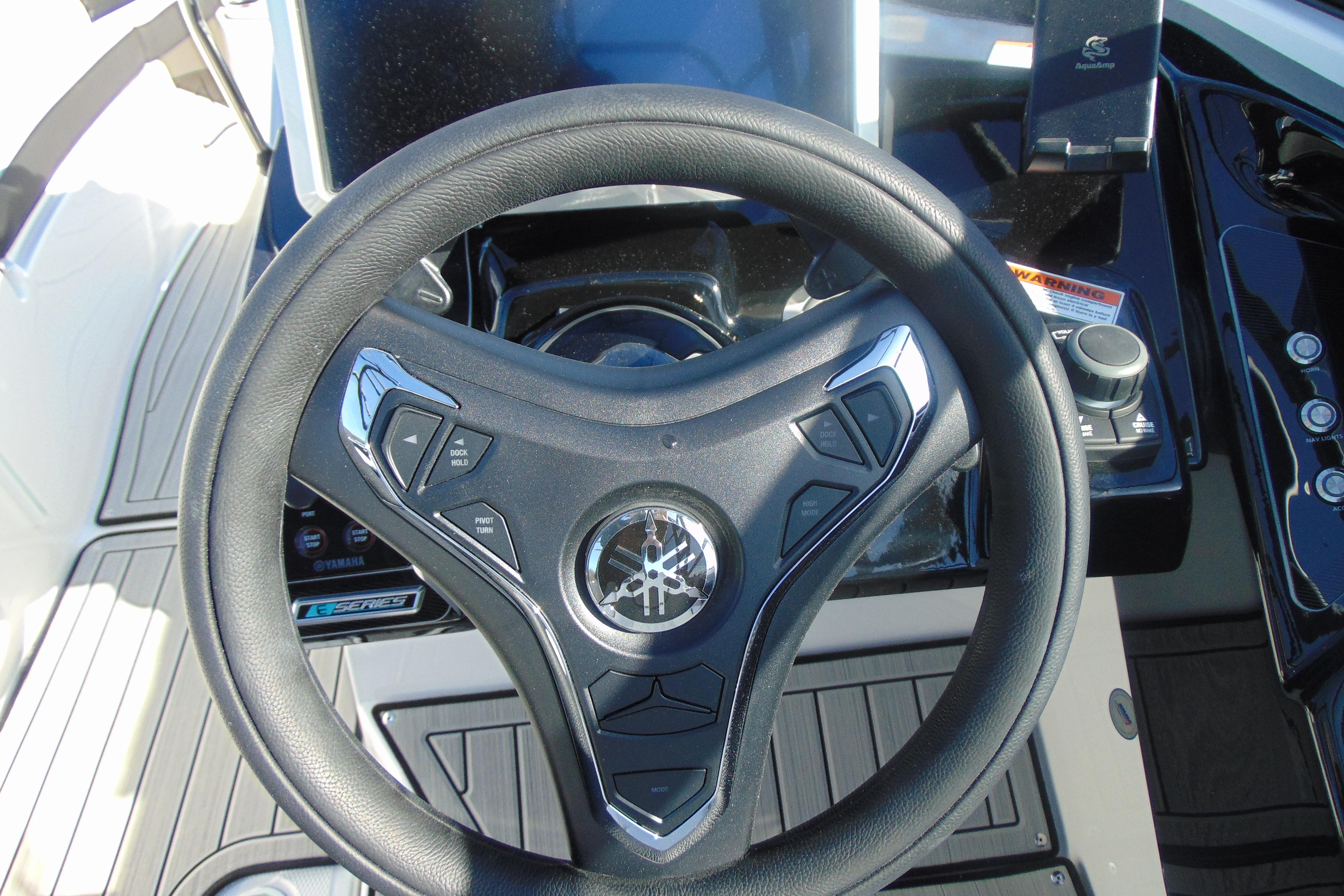 Steering wheel of 2026 Yamaha Boats 252SD, featuring modern controls and sleek design.