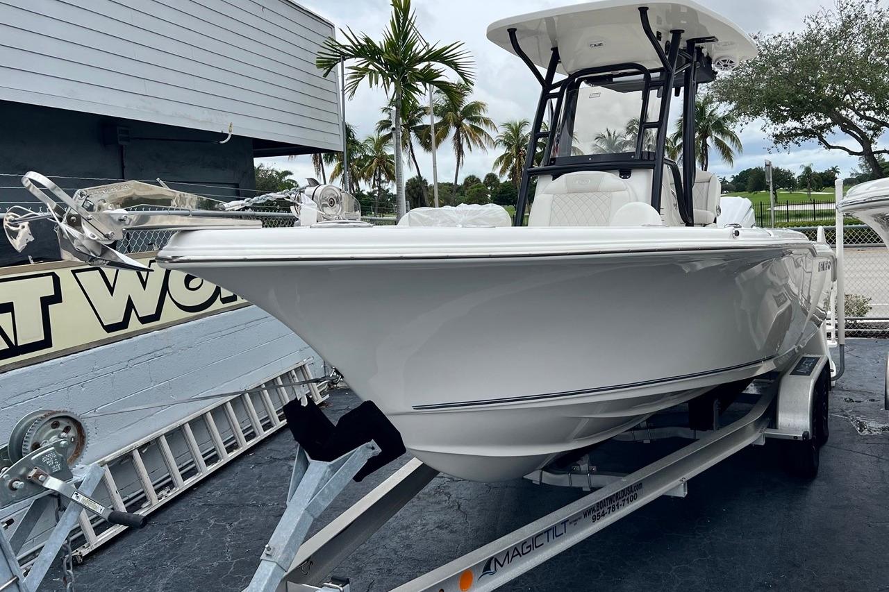 2026 Key West 239 FS boat on trailer, parked outdoors near palm trees.