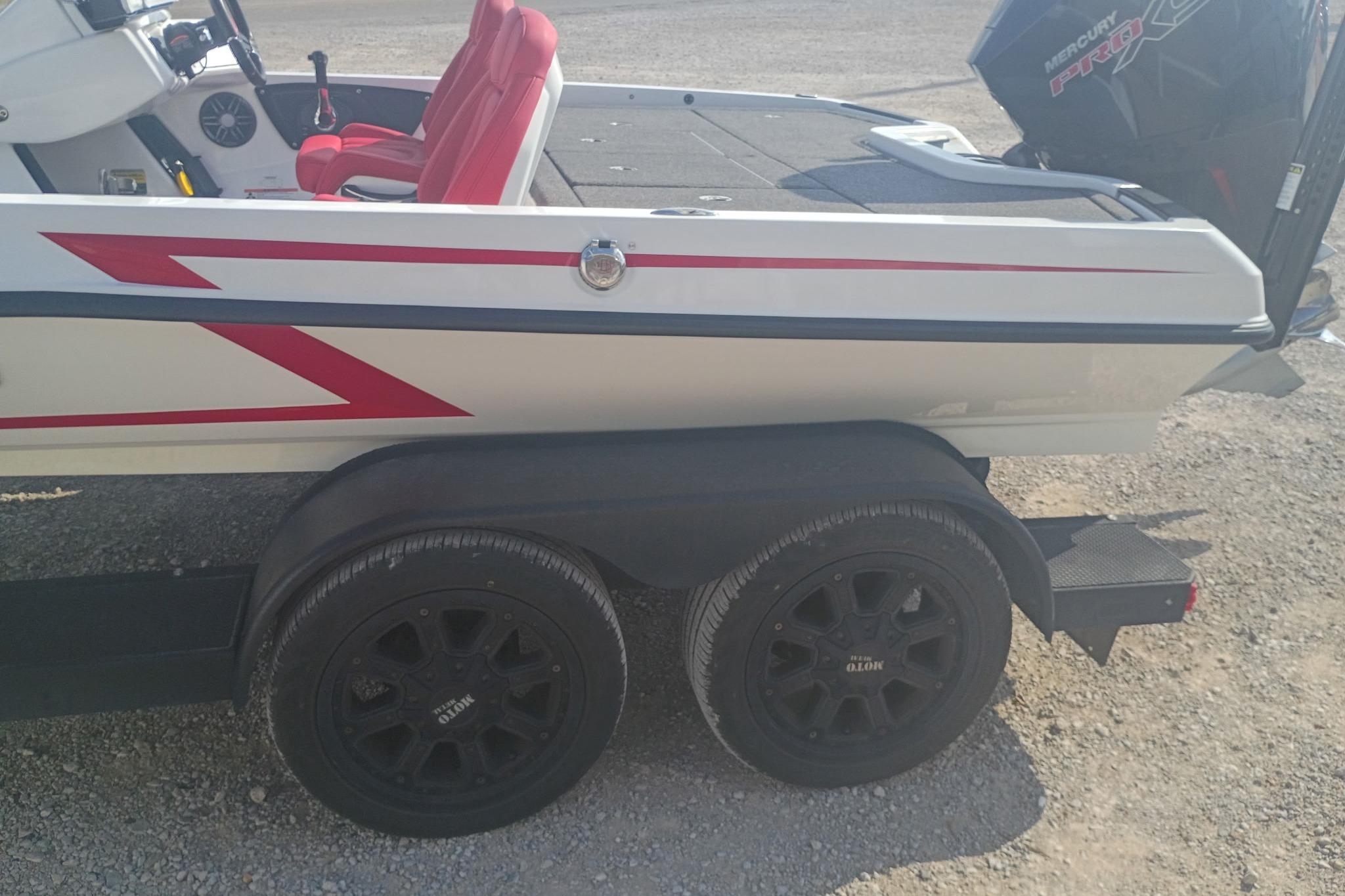 2024 iKon LX21 boat on trailer with red accents and Mercury engine.