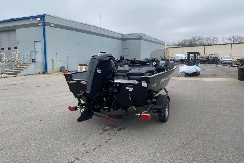 2026 Tracker Pro Guide V-16 SC boat on trailer in industrial area.