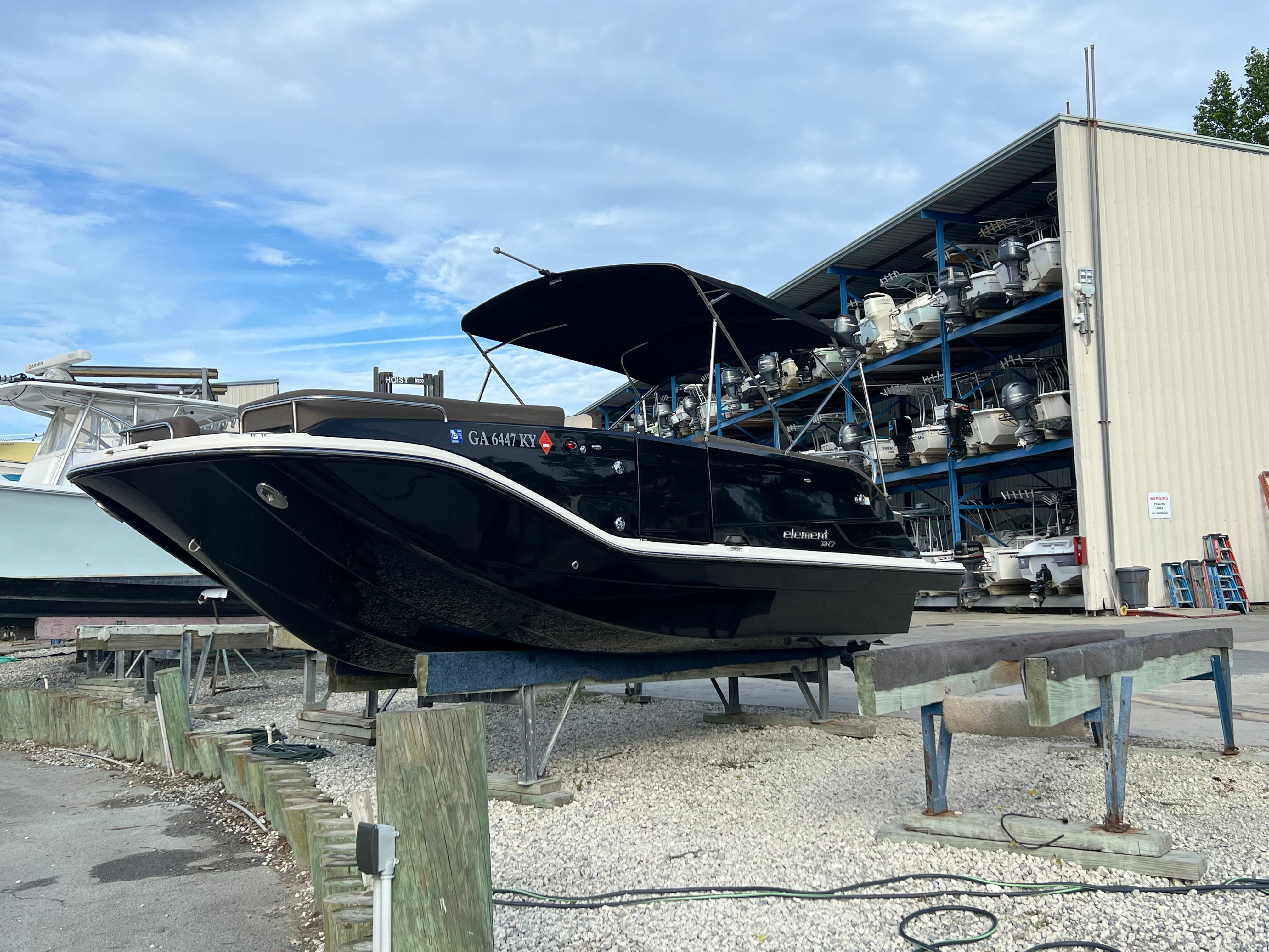 A 2019 Bayliner Element XR7 on a boat trailer. It features a sleek black hull design.