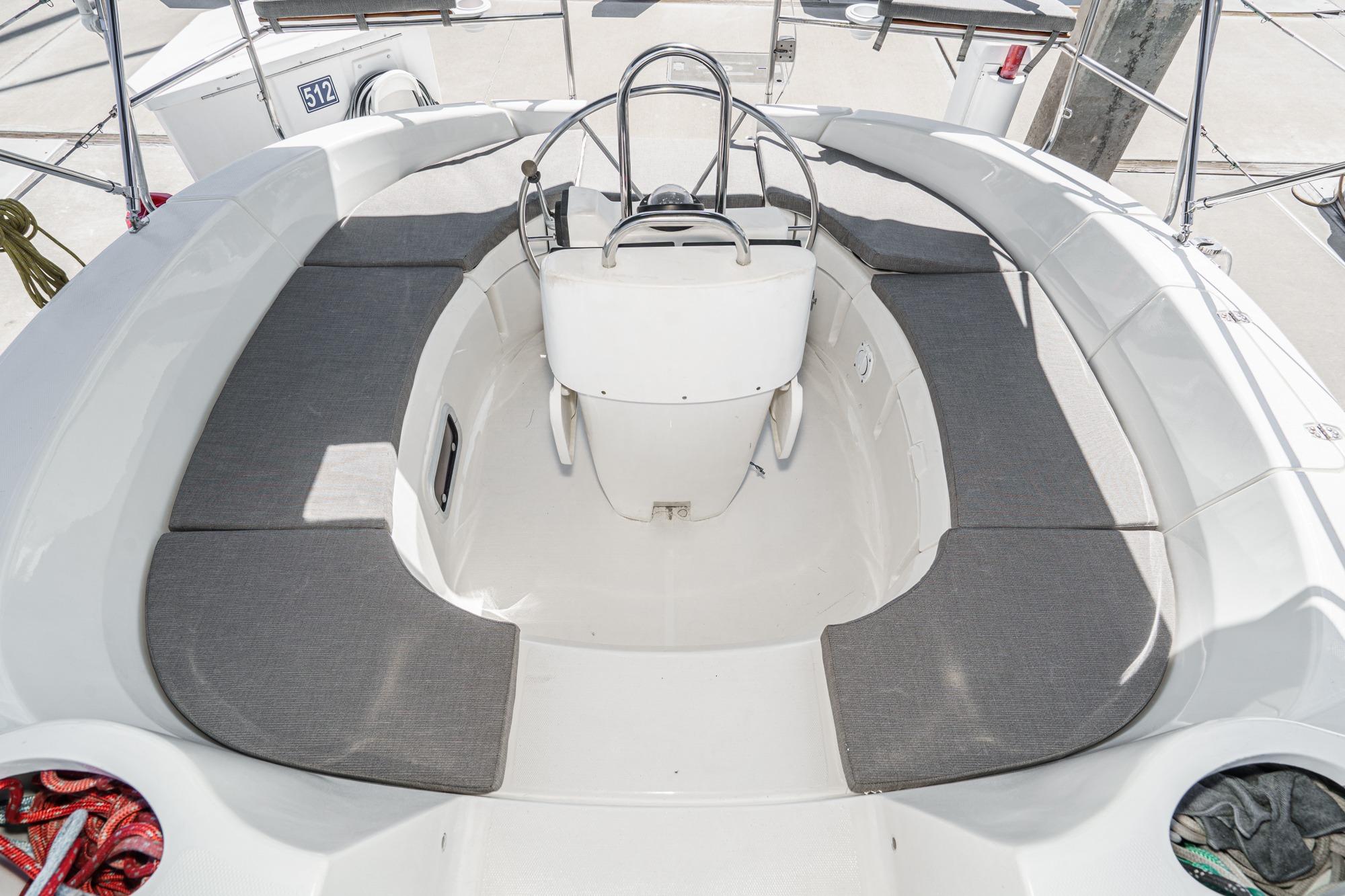 Spacious cockpit of a 1996 Hunter 376 sailboat with cushioned seating.