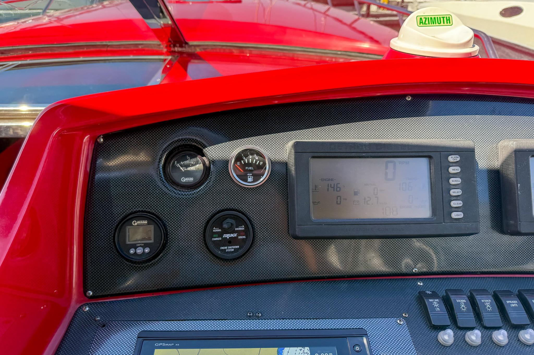 Dashboard of a 2002 Hallett Custom High Performance Express Cruiser with gauges and controls.