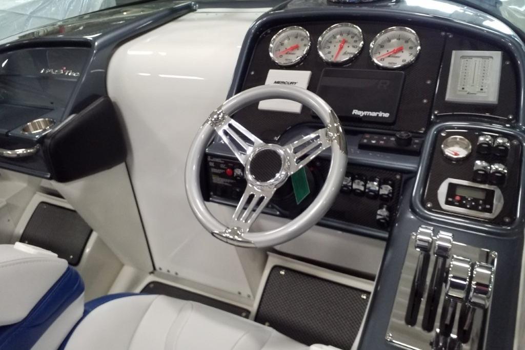 2019 Formula 382 FASTech boat cockpit with steering wheel and control panel.