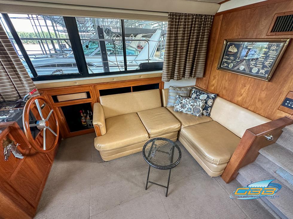 1989 Carver 3807 Aft Cabin interior with beige seating and nautical decor.