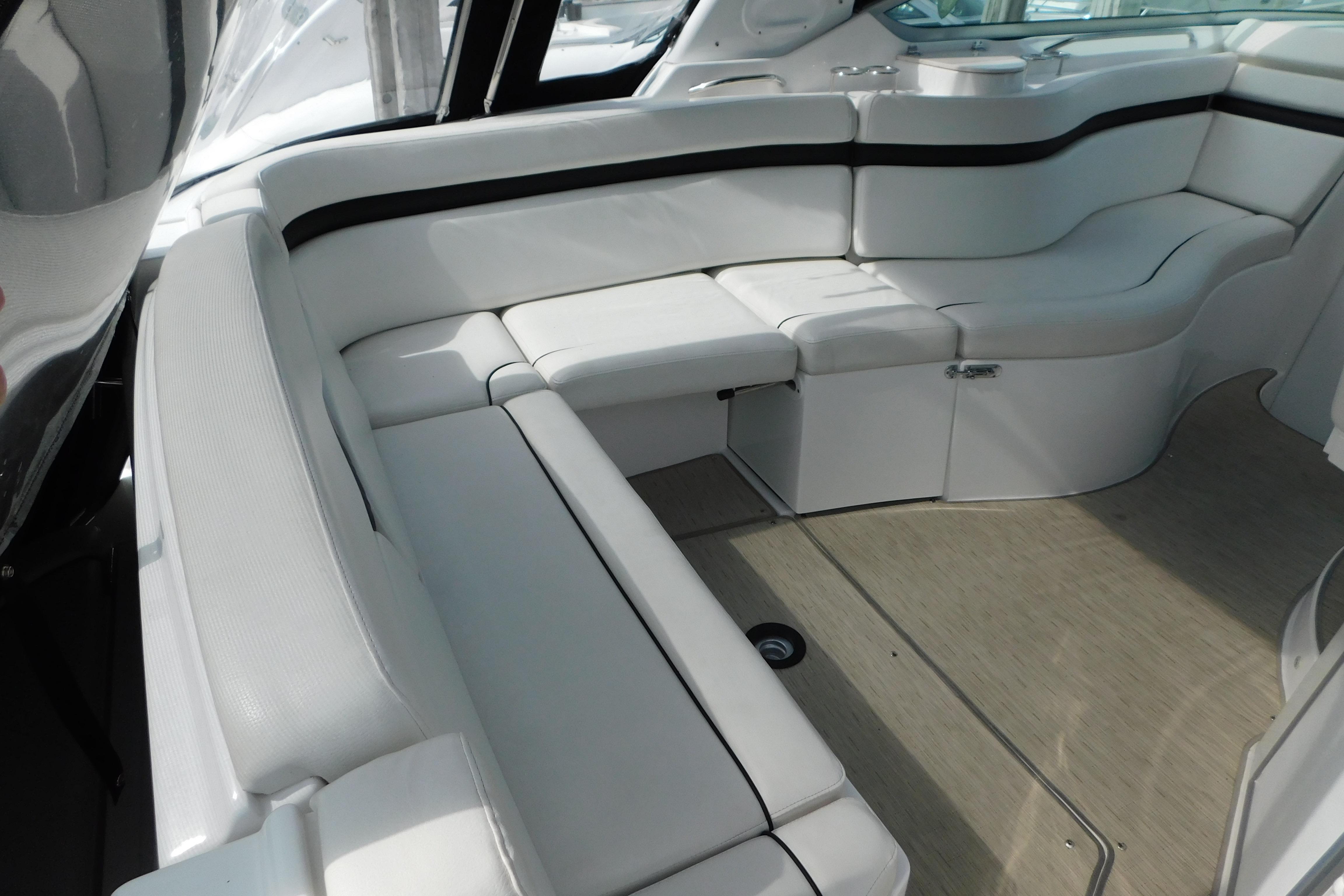 2017 Rinker EX 320 boat interior with white cushioned seating and sleek design.