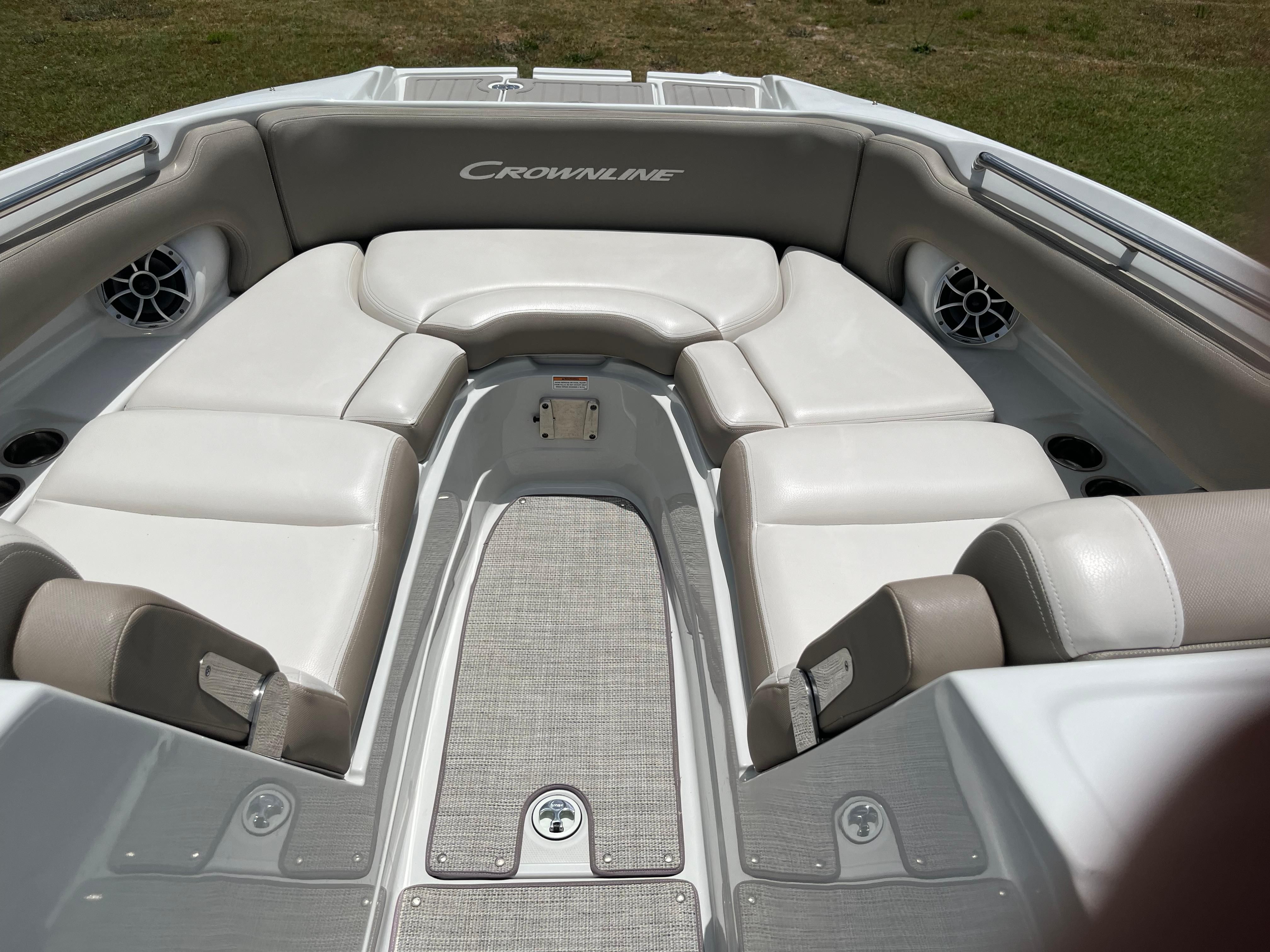 The image shows the bow area of a Crownline E 285 boat with white upholstery.