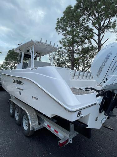 2014 Everglades 325 Center Console boat on trailer, featuring Mercury engine.